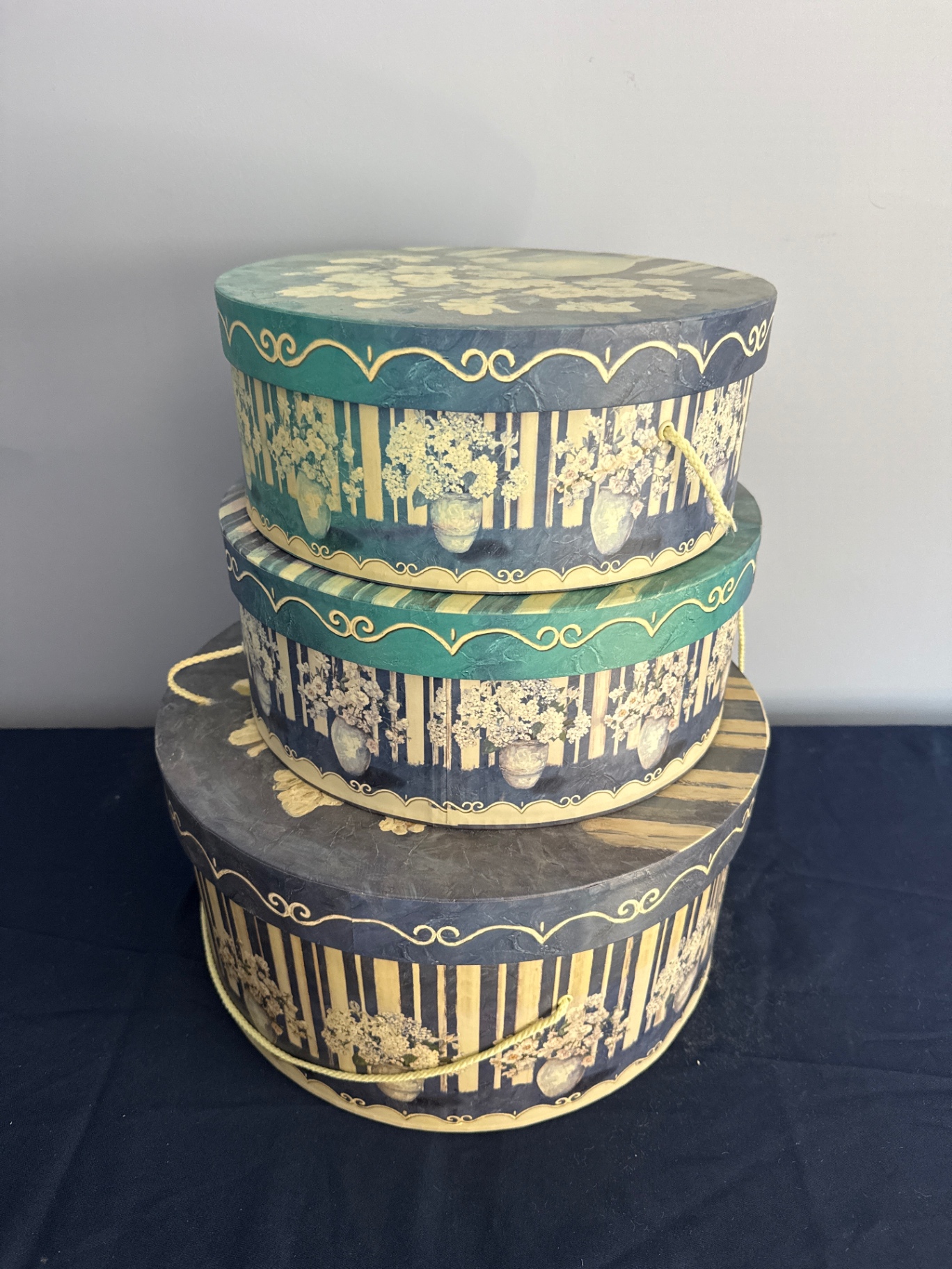 Stack of decorative round hat boxes with teal and gold patterns - image 1 of 2