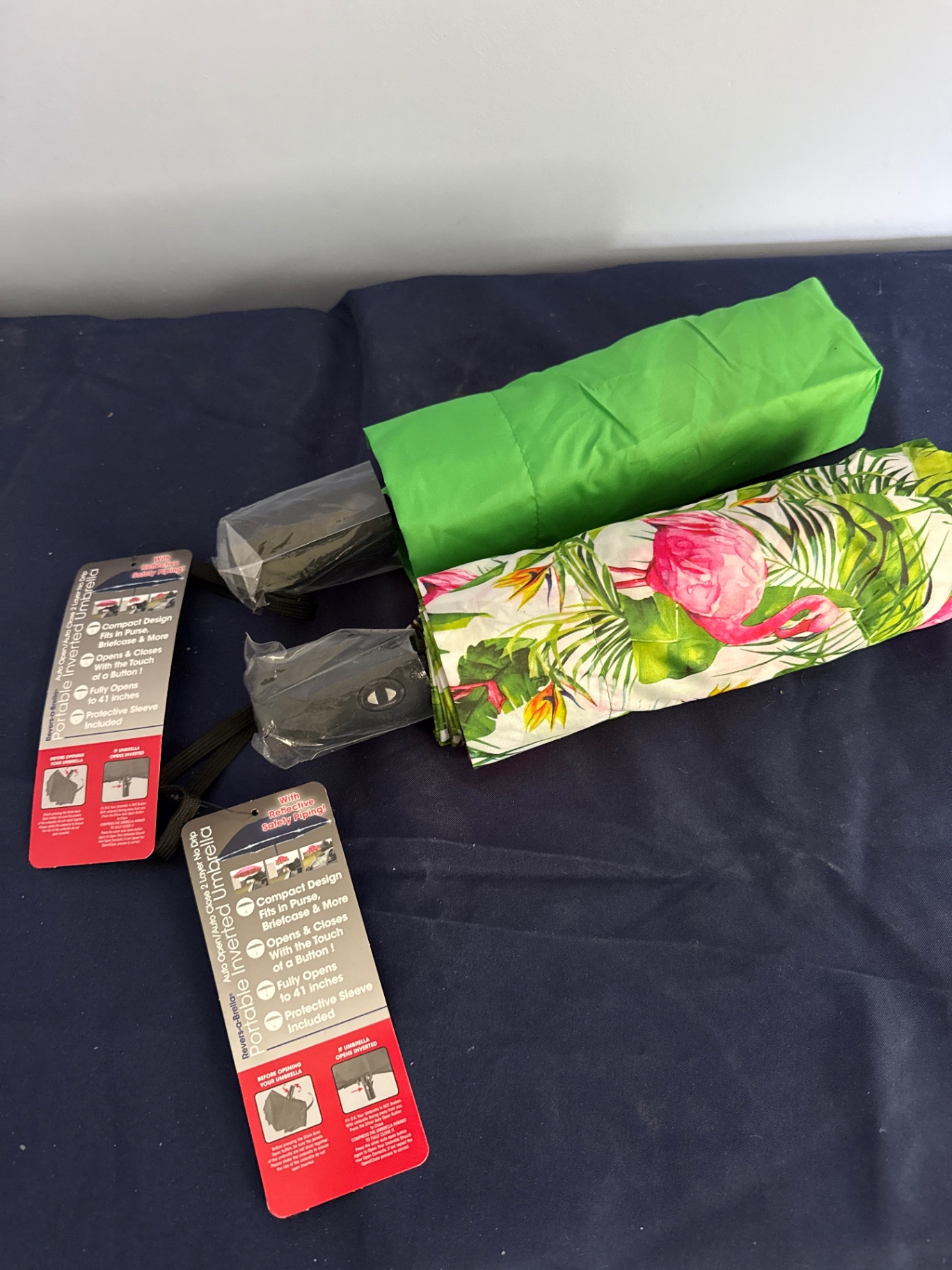 Two compact inverted umbrellas with protective sleeves - image 1 of 2