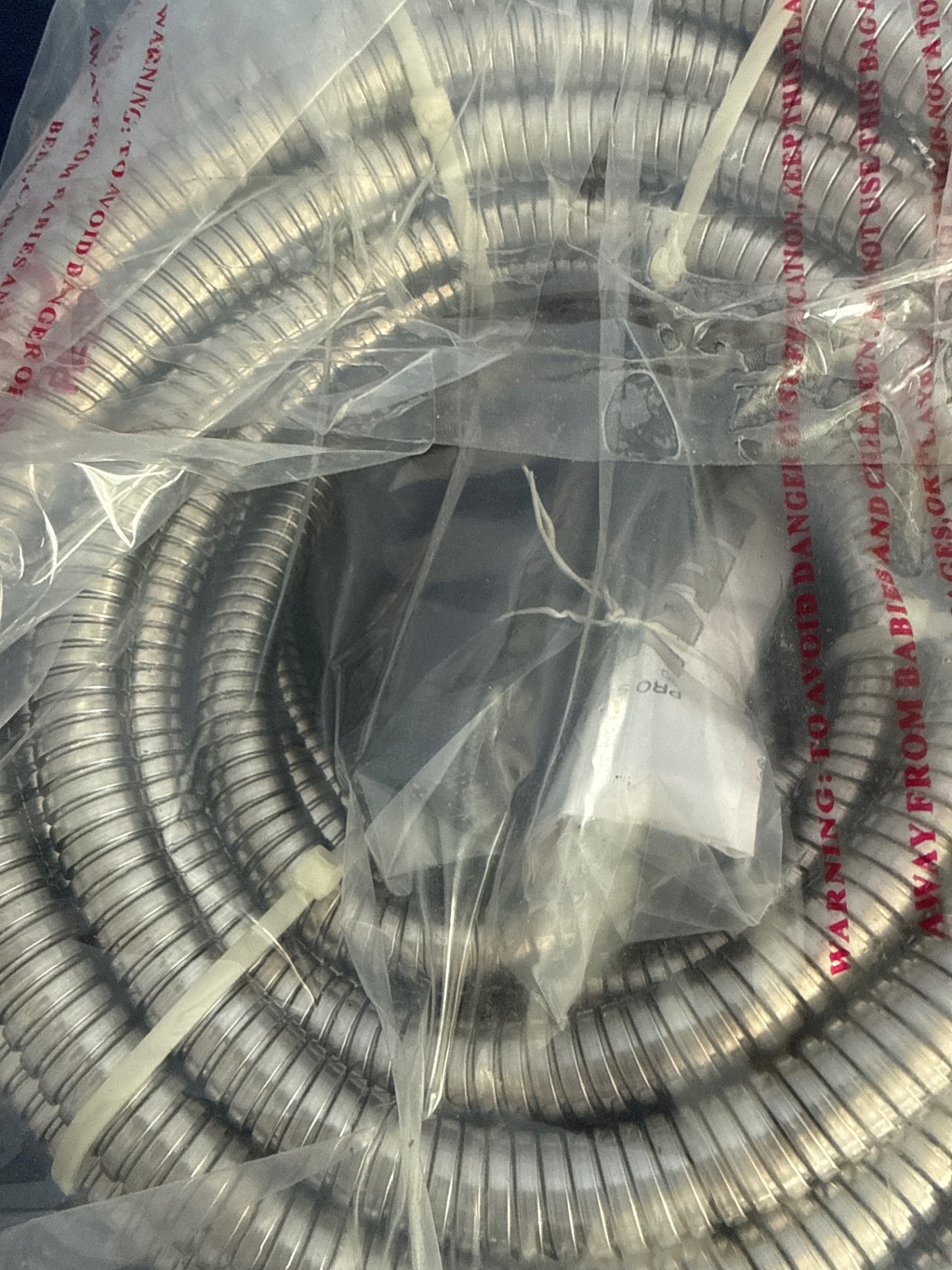 Coiled flexible metal hose and garden hands - image 2 of 3
