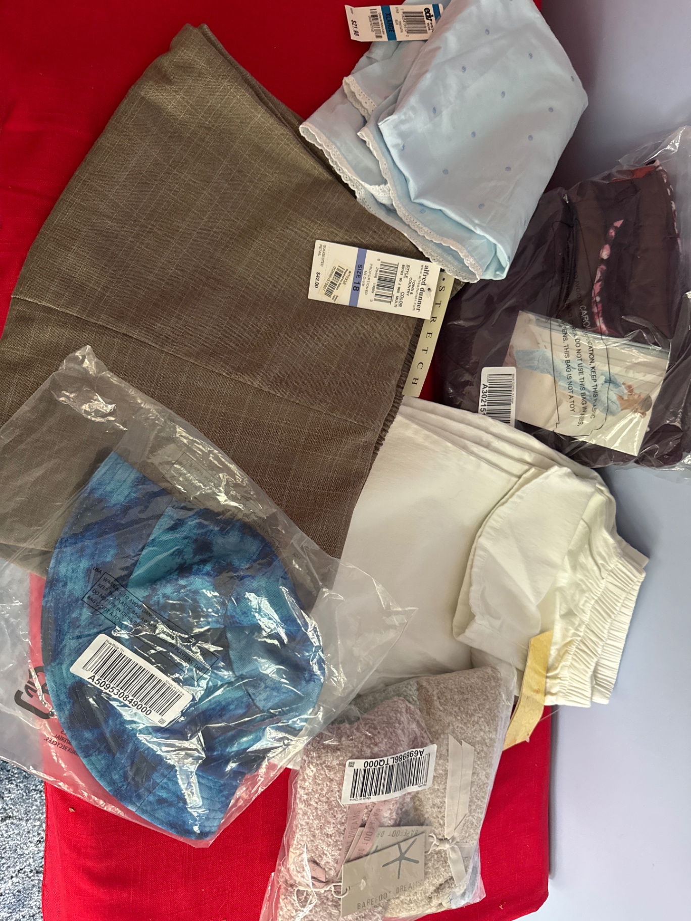 Assorted new clothing and textiles - image 1 of 7