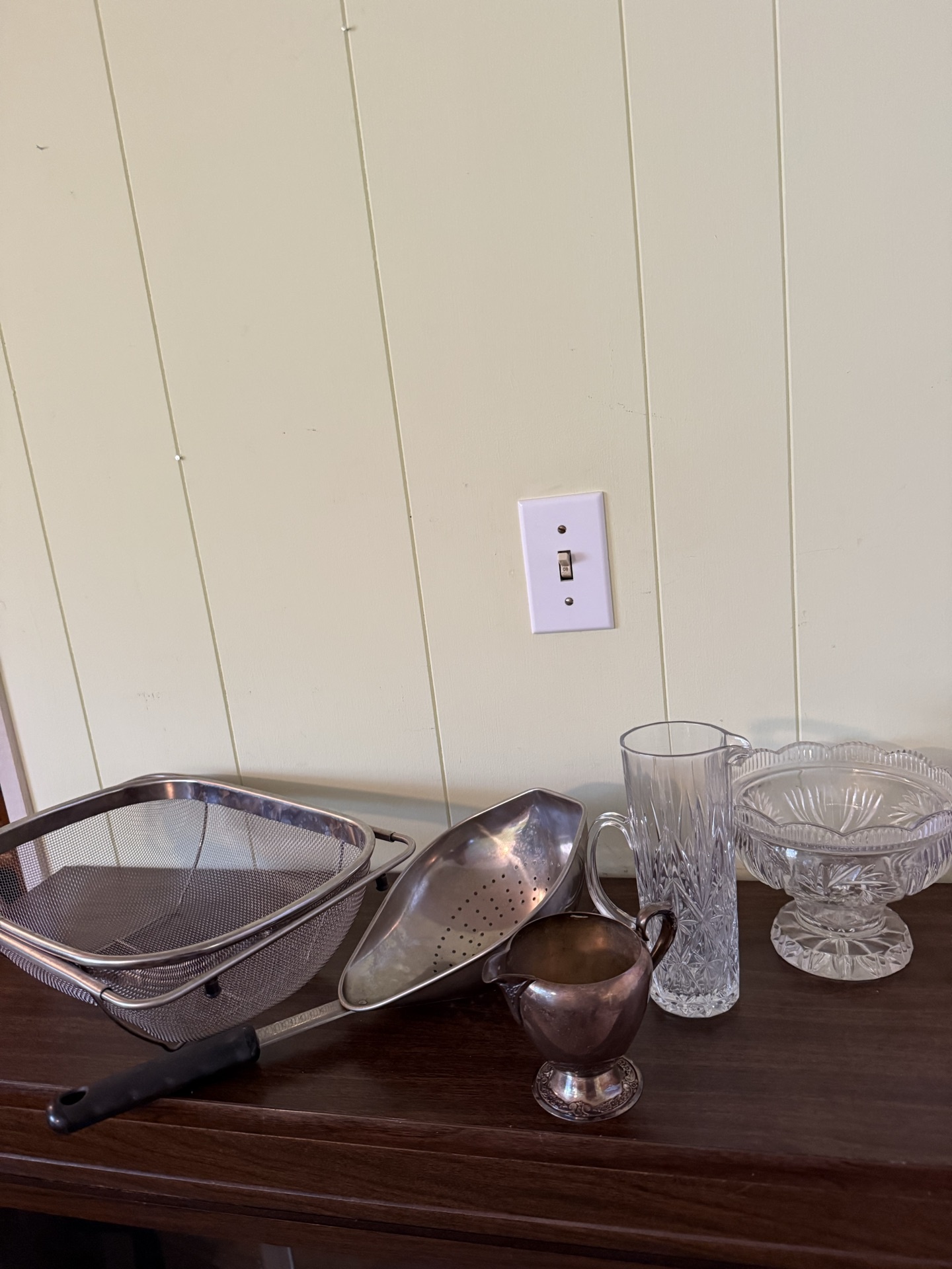 Vintage kitchenware collection including silver-plated creamer, crystal glassware, strainers and wire dish rack - image 1 of 7