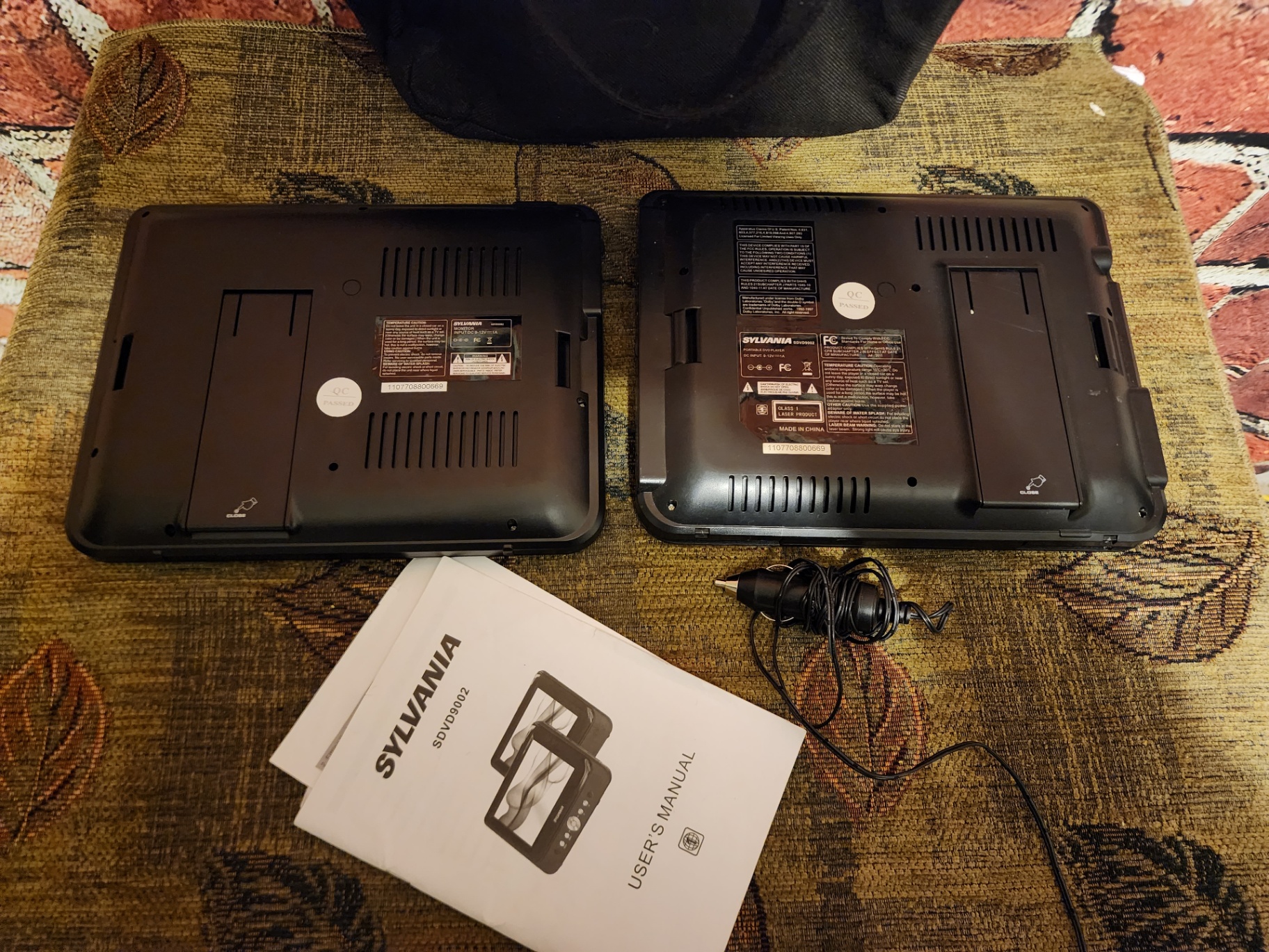 Two Sylvania portable DVD players with power adapter and manual - image 2 of 7