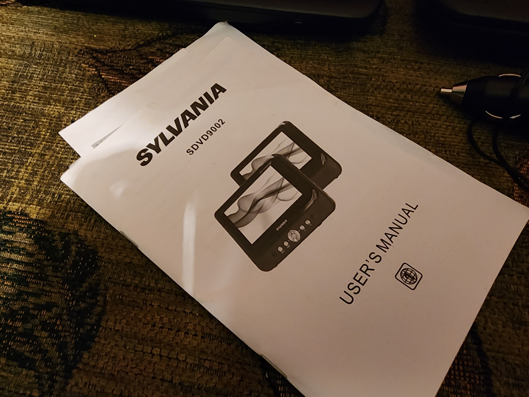 Two Sylvania portable DVD players with power adapter and manual - image 7 of 7