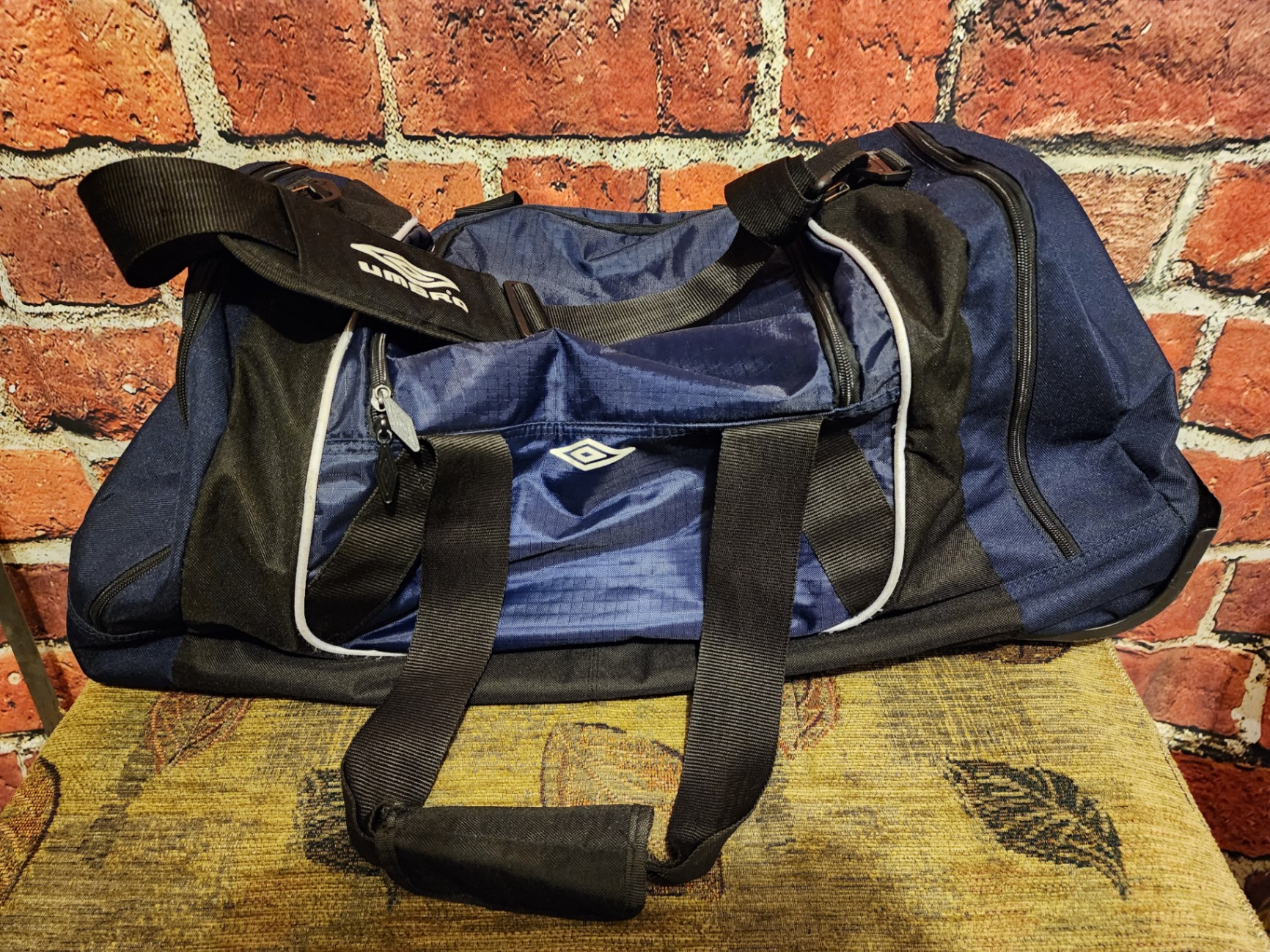 Blue Umbro duffel bag and black wheeled gear case - image 1 of 11