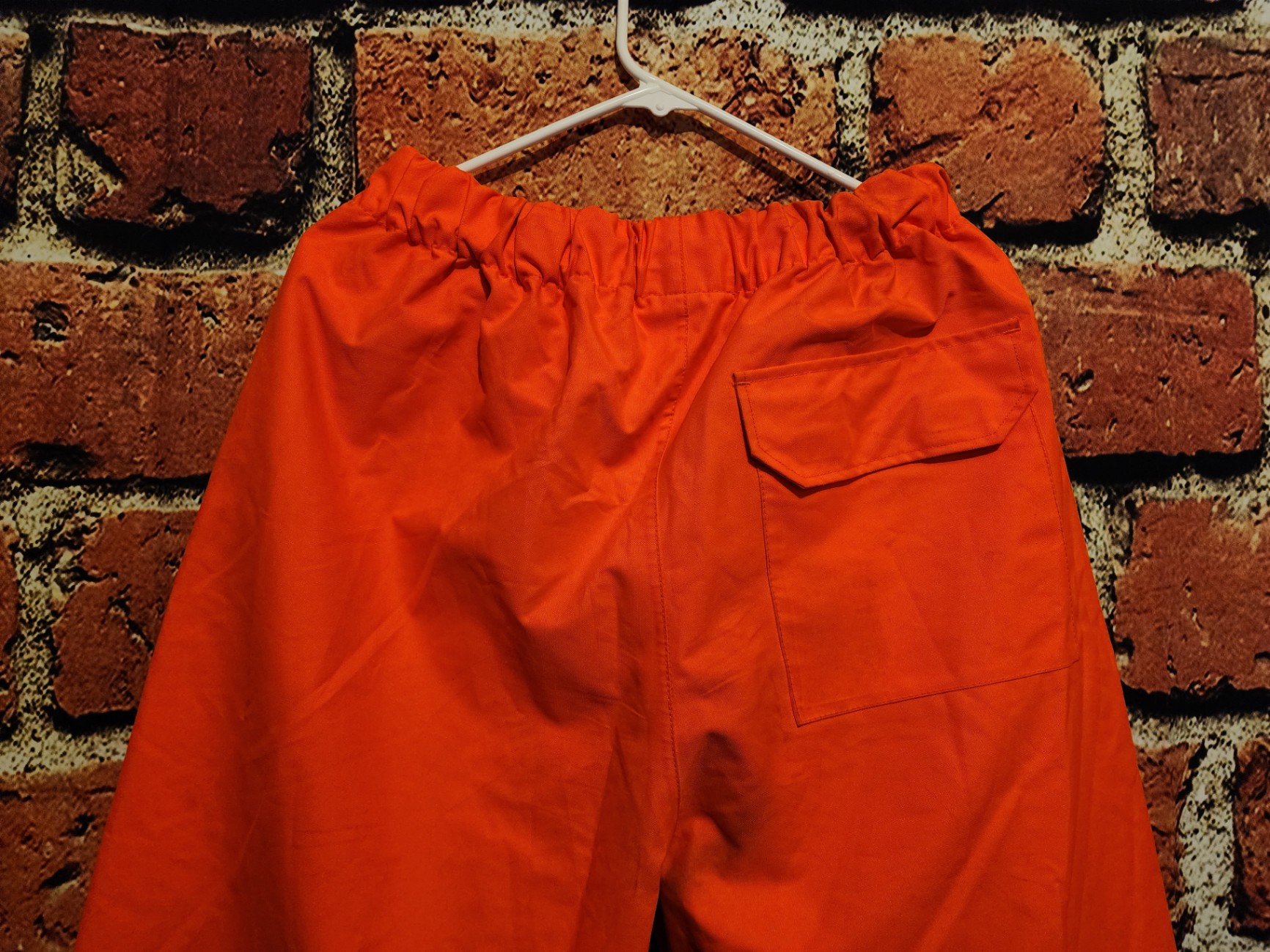 Orange high-visibility safety pants with reflective bands - image 4 of 9