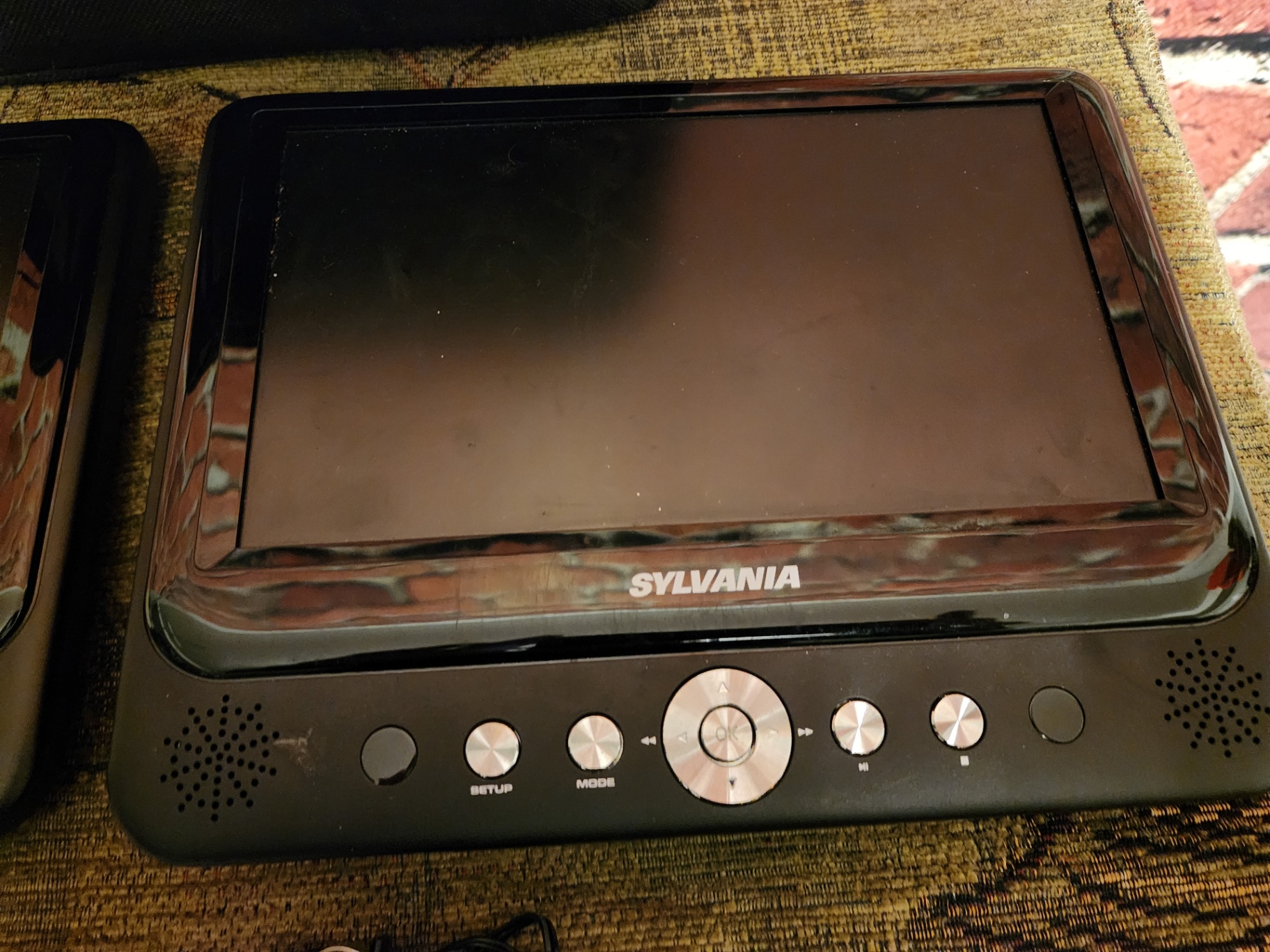 Two Sylvania portable DVD players with power adapter and manual - image 6 of 7