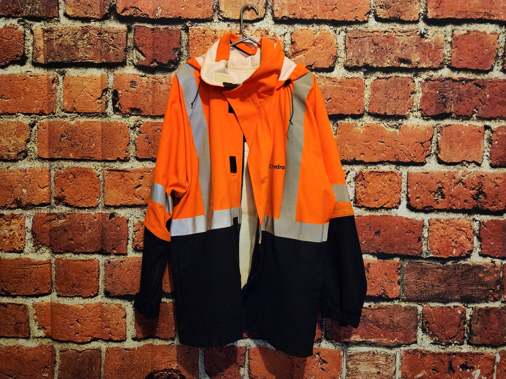 Orange high-visibility safety jacket with reflective stripes - image 1 of 9