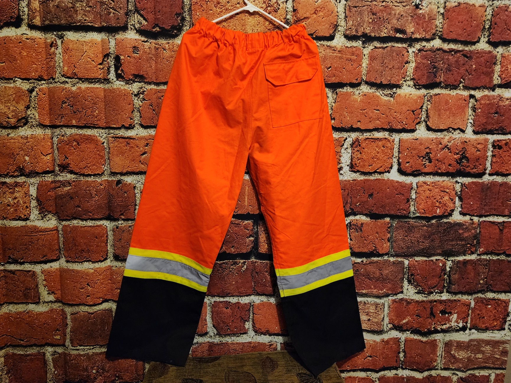 Orange high-visibility safety pants with reflective bands - image 2 of 9