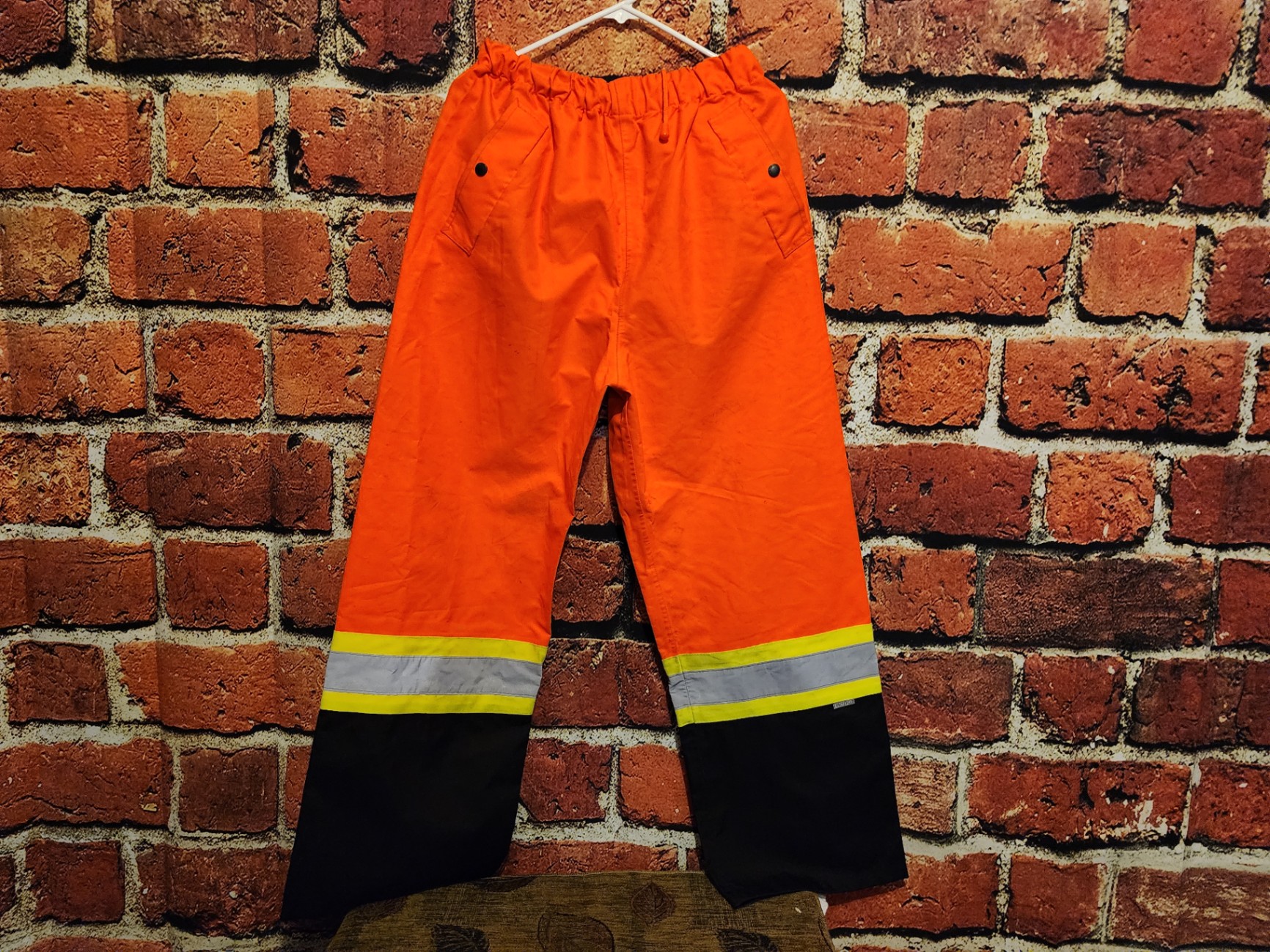 Orange high-visibility safety pants with reflective bands - image 1 of 9