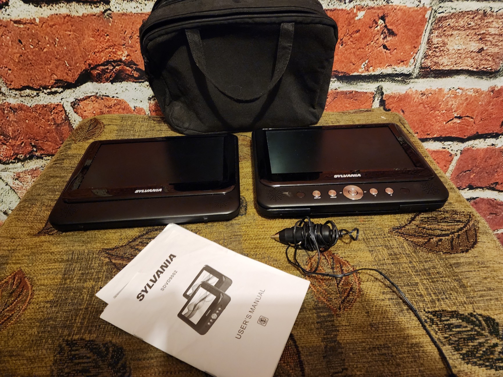 Two Sylvania portable DVD players with power adapter and manual - image 1 of 7