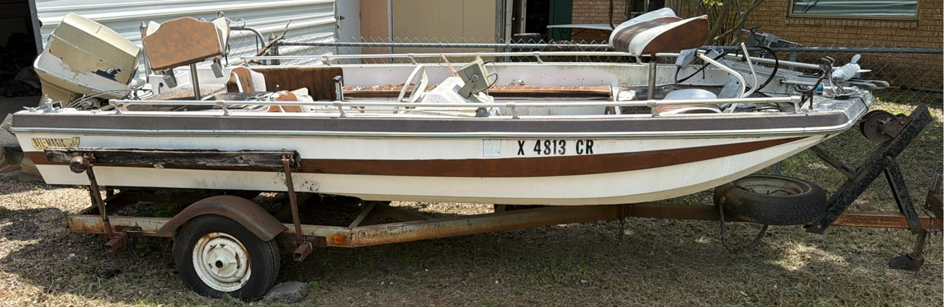 Aluminum fishing boat on trailer with outboard motor - image 1 of 9