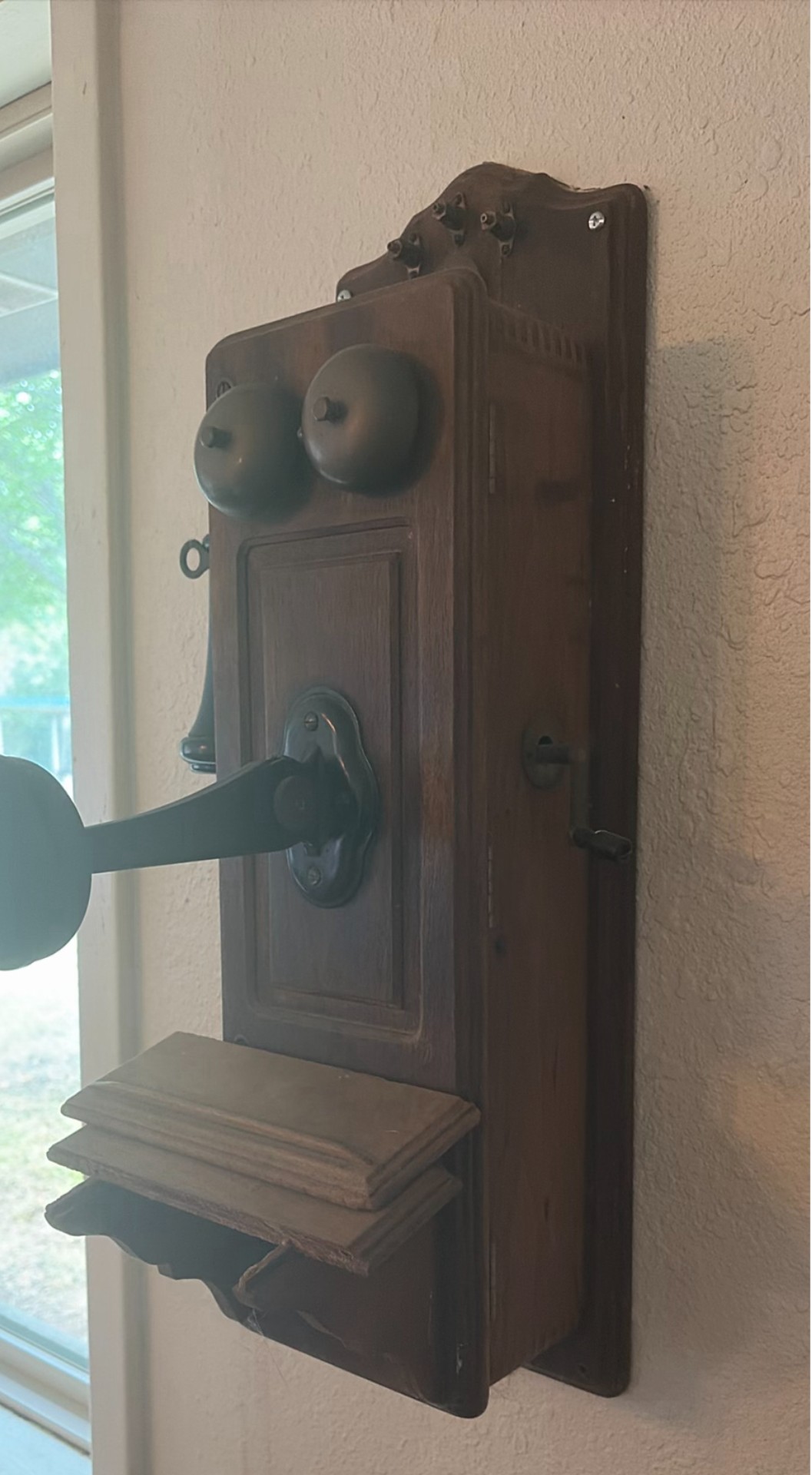 Vintage wall-mounted ship wheel clock, antique telephone, and wooden wall rack - image 4 of 8