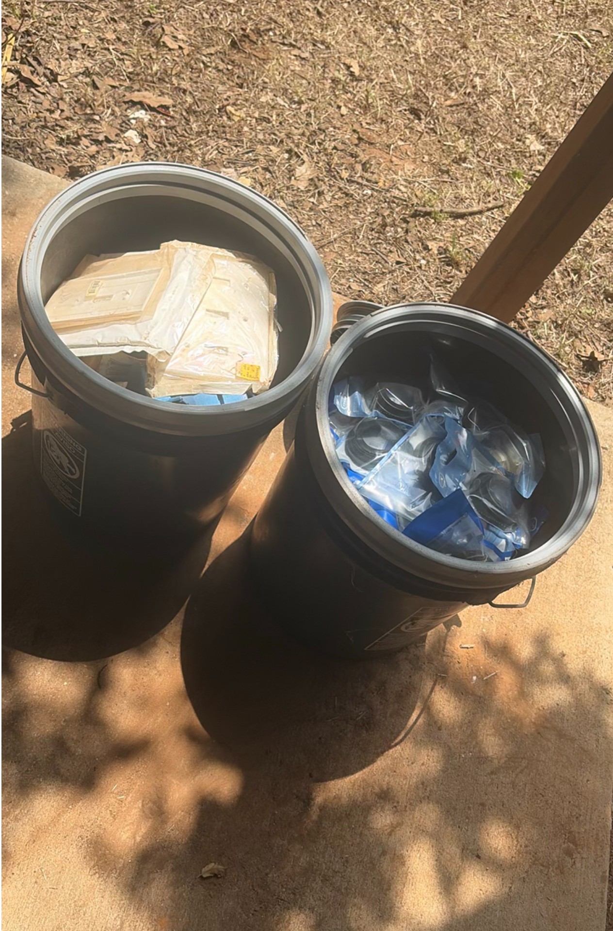 Assorted workshop waste and welding supplies in trash containers - image 1 of 9