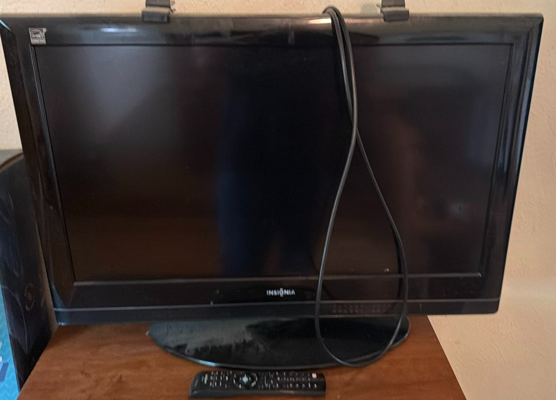 Insignia flat-screen TV with built-in DVD player on wooden dresser - image 1 of 5