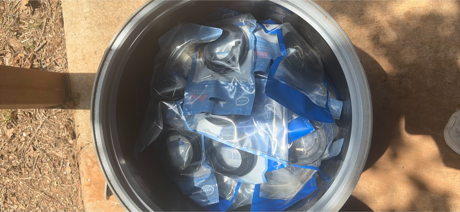 Assorted workshop waste and welding supplies in trash containers - image 3 of 9