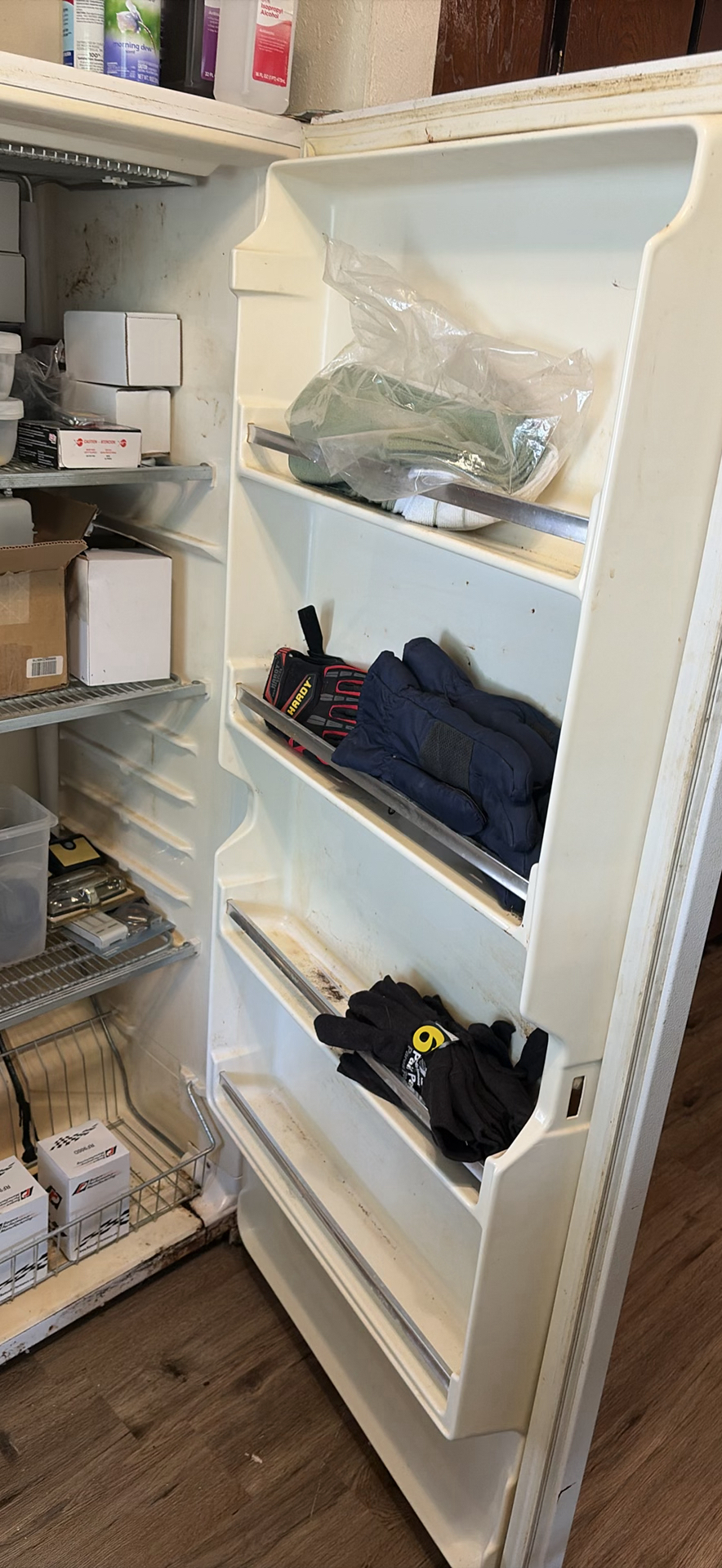 White upright refrigerator with assorted stored items - image 3 of 4