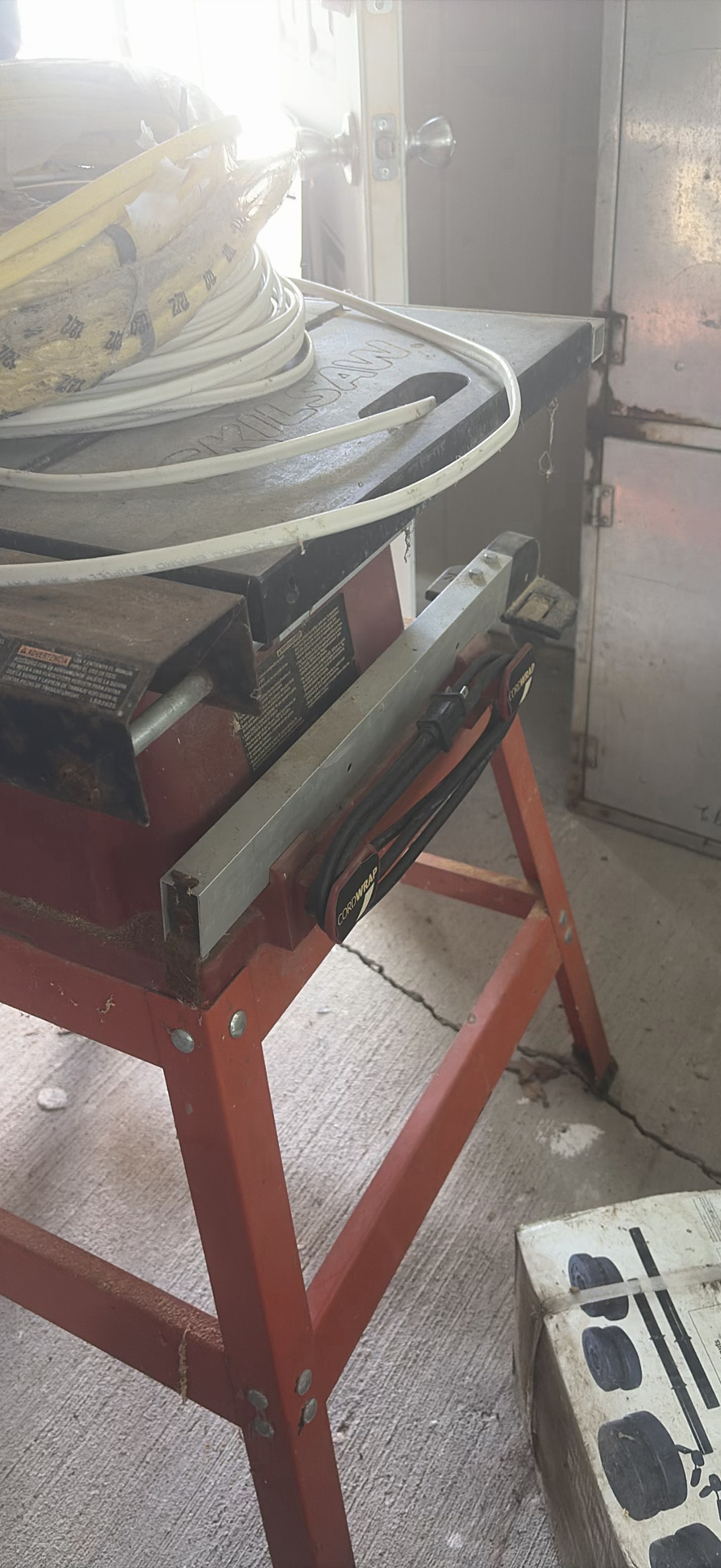 SkilSaw table saw on red work stand with coiled cables - image 5 of 6