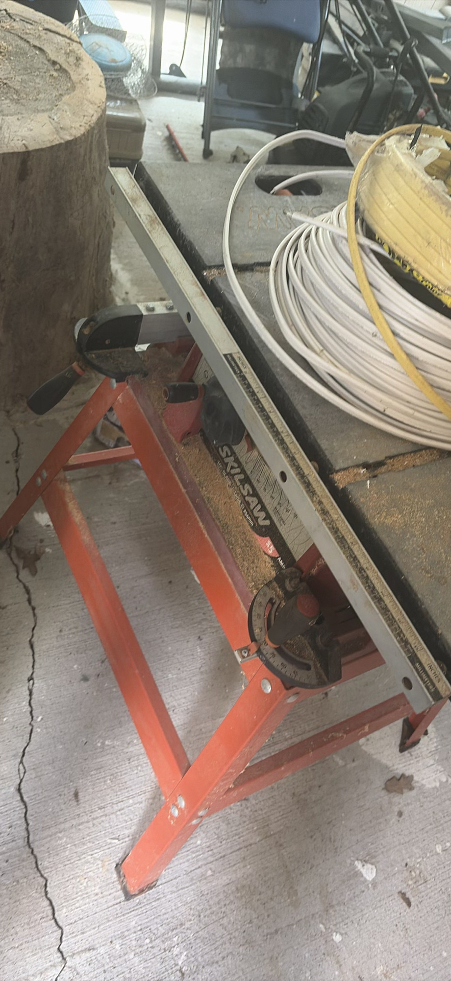 SkilSaw table saw on red work stand with coiled cables - image 4 of 6