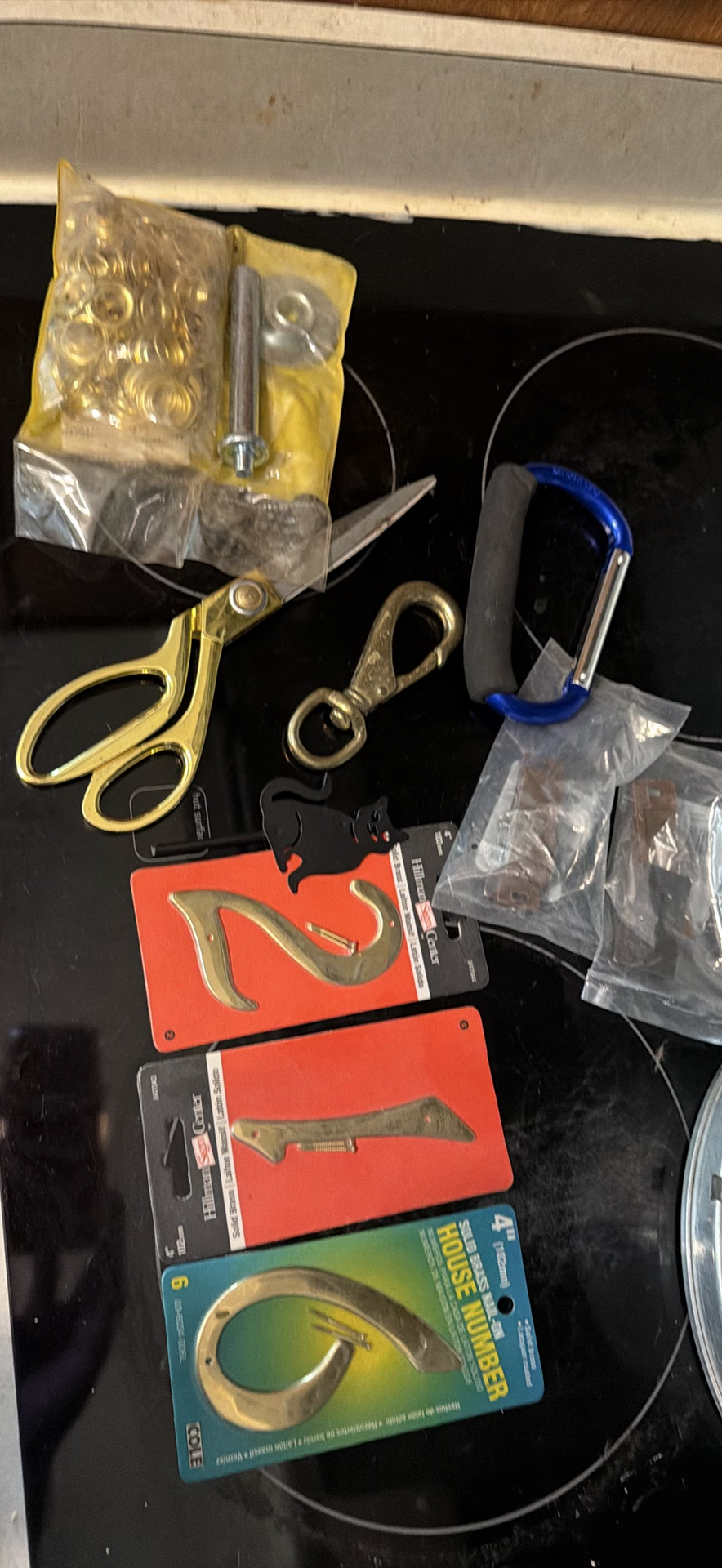 Assorted hardware items including brass hooks and carabiner - image 1 of 5