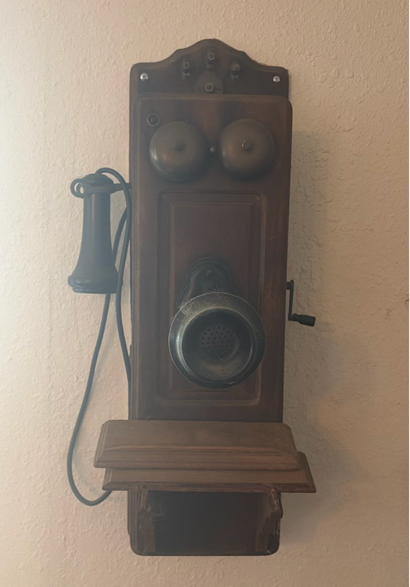 Vintage wall-mounted ship wheel clock, antique telephone, and wooden wall rack - image 2 of 8