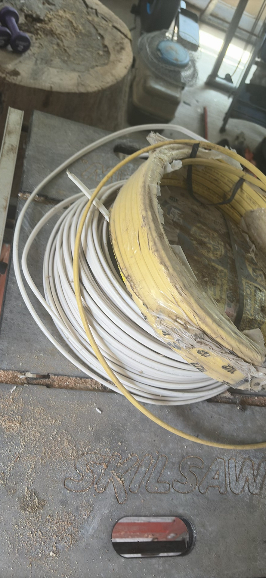 SkilSaw table saw on red work stand with coiled cables - image 3 of 6
