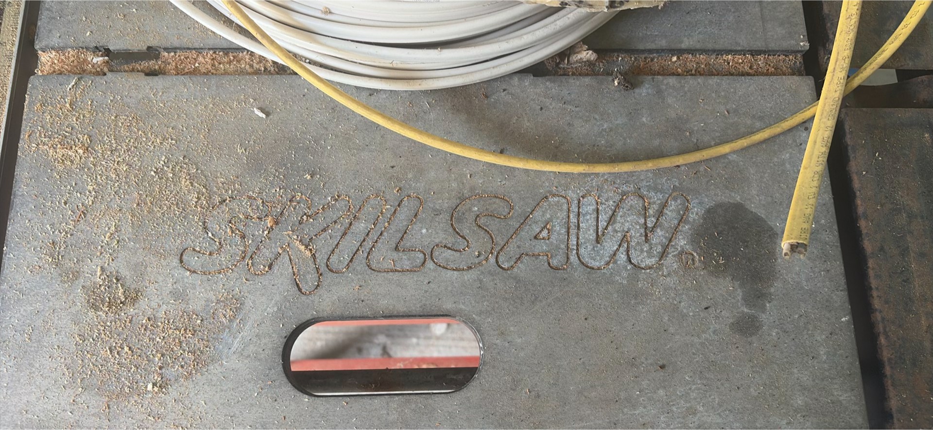 SkilSaw table saw on red work stand with coiled cables - image 2 of 6