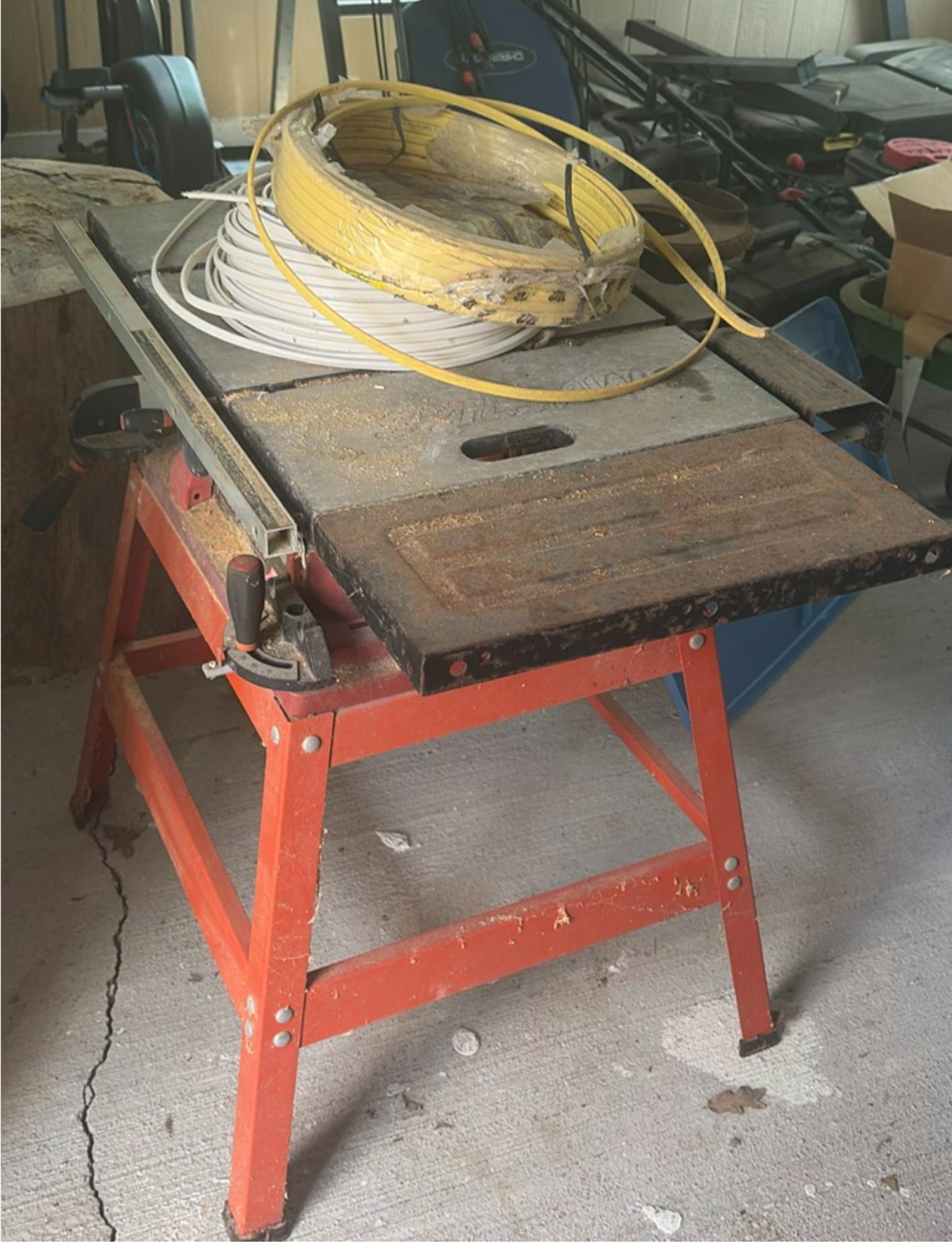 SkilSaw table saw on red work stand with coiled cables - image 1 of 6