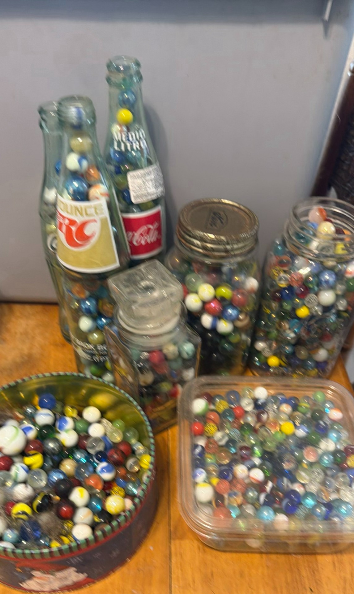 Assorted glass marbles in jars, bowls, and bottles - image 1 of 5