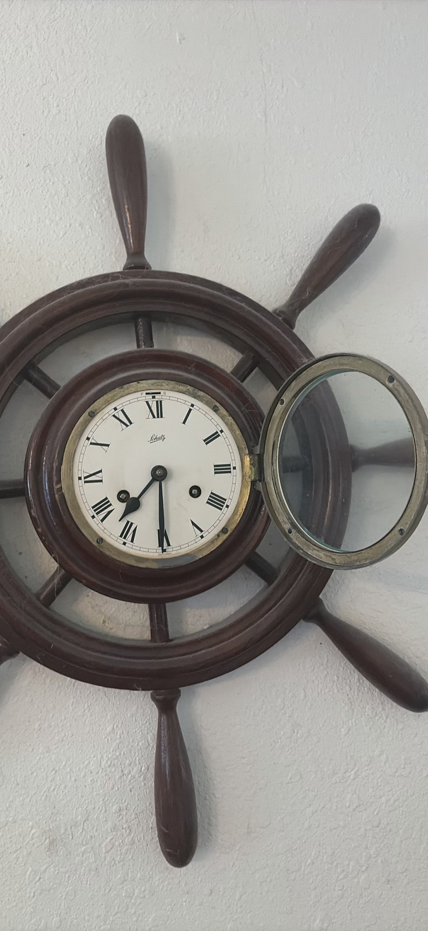 Vintage wall-mounted ship wheel clock, antique telephone, and wooden wall rack - image 6 of 8