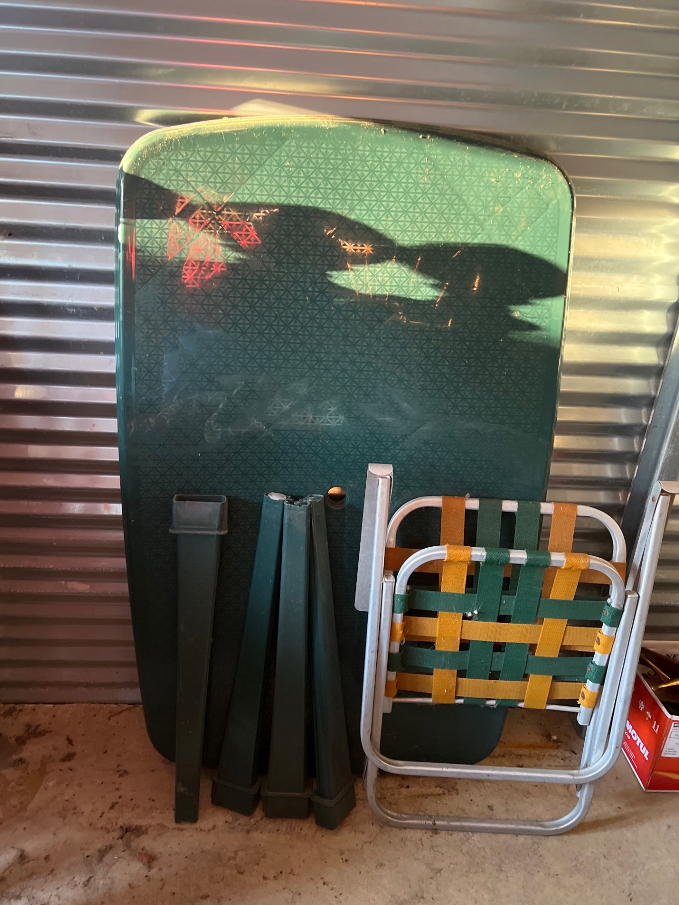 A Folding metal chair with woven straps and Plastic Table components - image 1 of 4