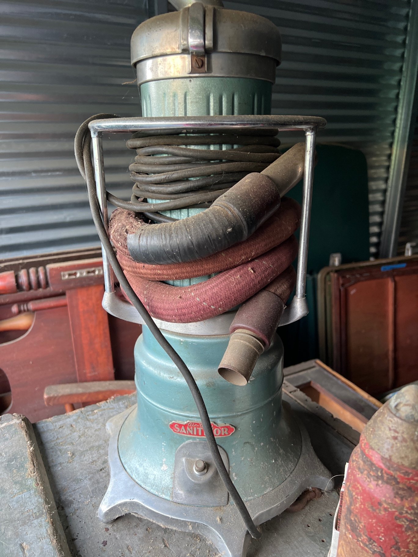 Vintage vacuum cleaner, rusted cylinder, and vintage books - image 5 of 6