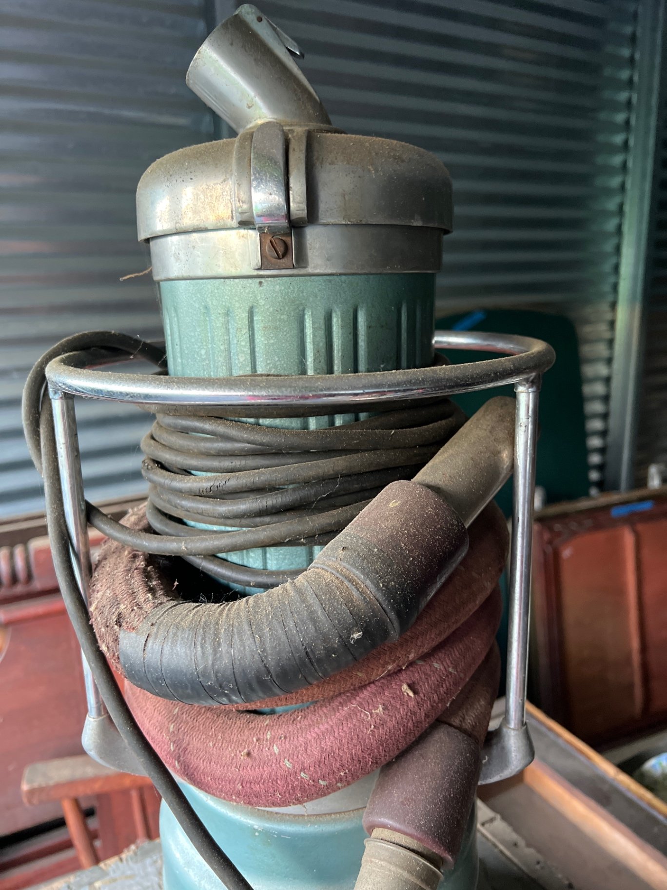 Vintage vacuum cleaner, rusted cylinder, and vintage books - image 2 of 6