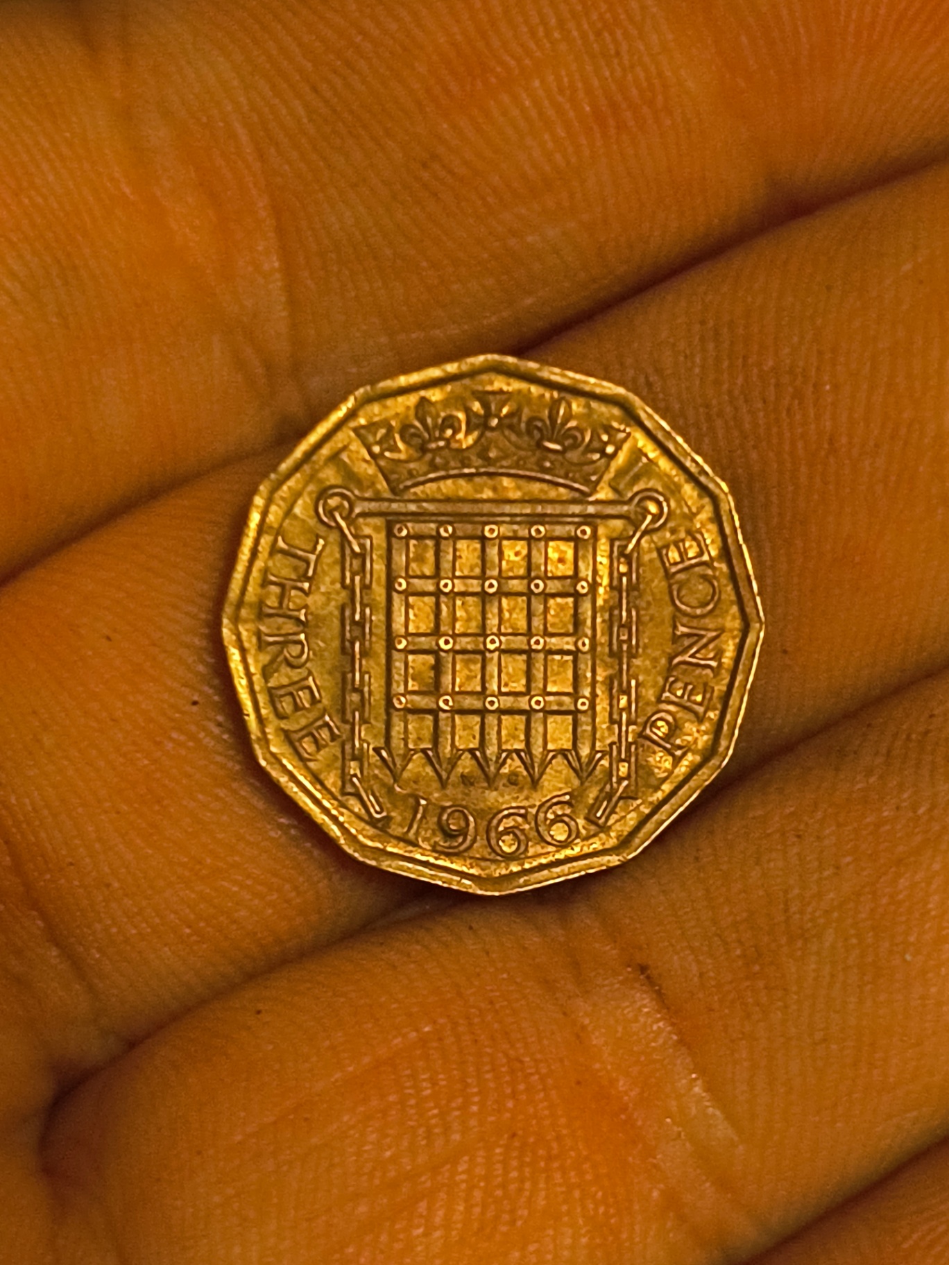 a 1966 twelve-sided piece and a Queen Elizabeth II portrait coin - image 1 of 2