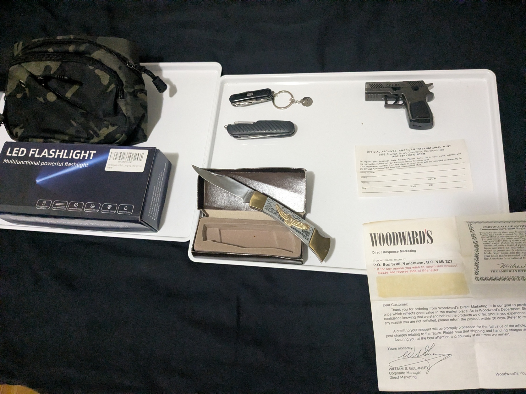 Mixed Outdoor & Collectible Lot – Knife, Flashlight, Tactical Bag, Replica Pistol Torch Lighter, Multi-Tools & Vintage Paperwork - image 1 of 12