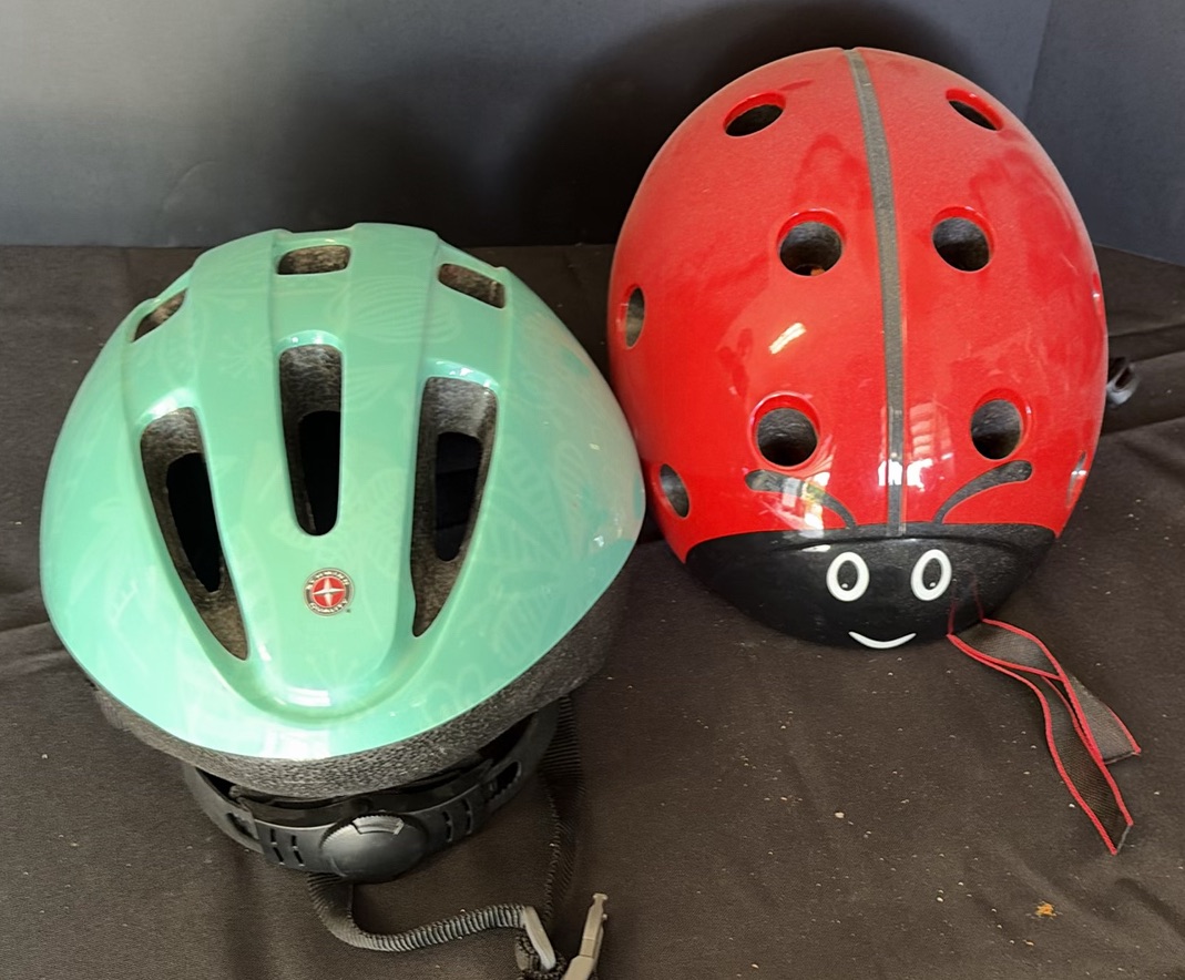 Green Schwinn bicycle helmet and red ladybug helmet - image 1 of 3