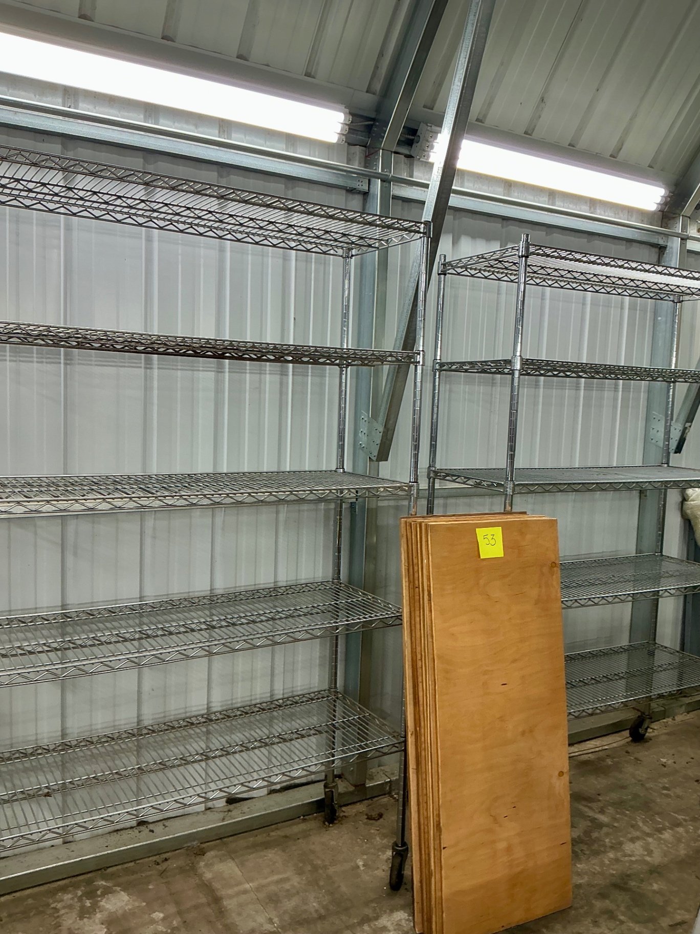 Mobile wire shelving units with plywood boards - image 1 of 3