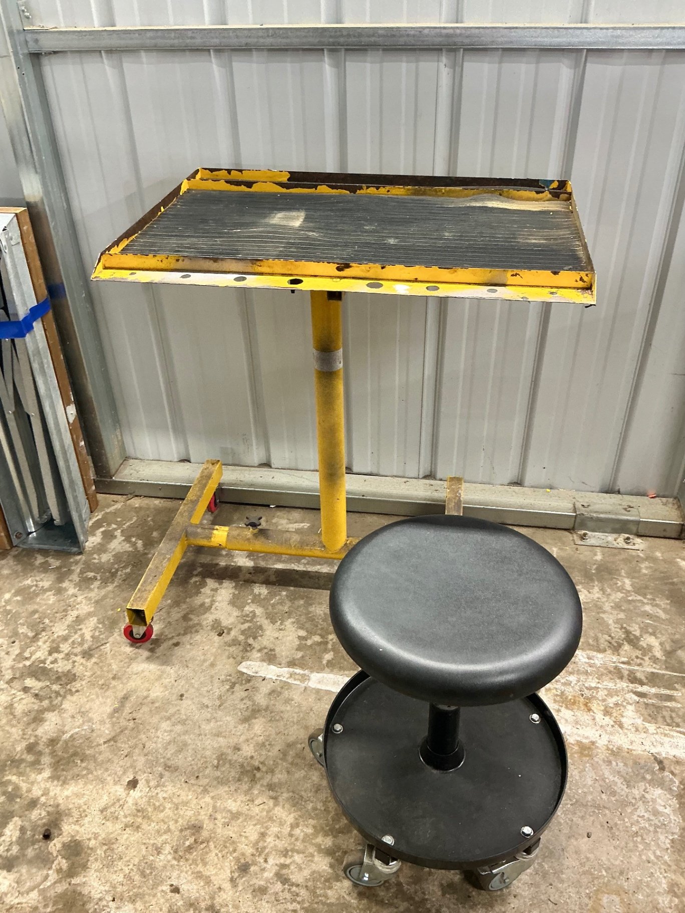 Yellow mobile work stand with ribbed tabletop and rolling stool - image 2 of 3
