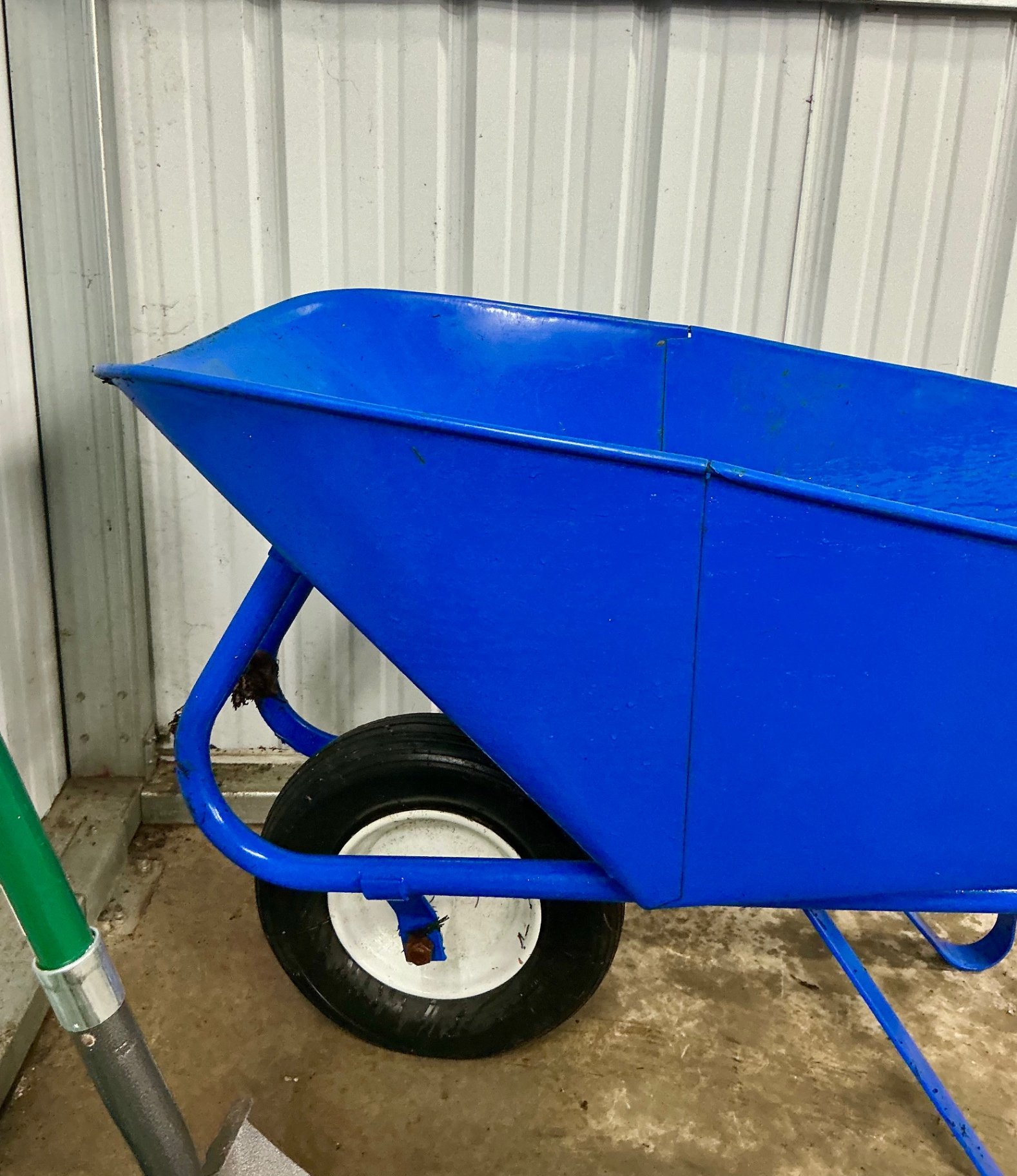 Blue wheelbarrow with garden tools and hose - image 5 of 6