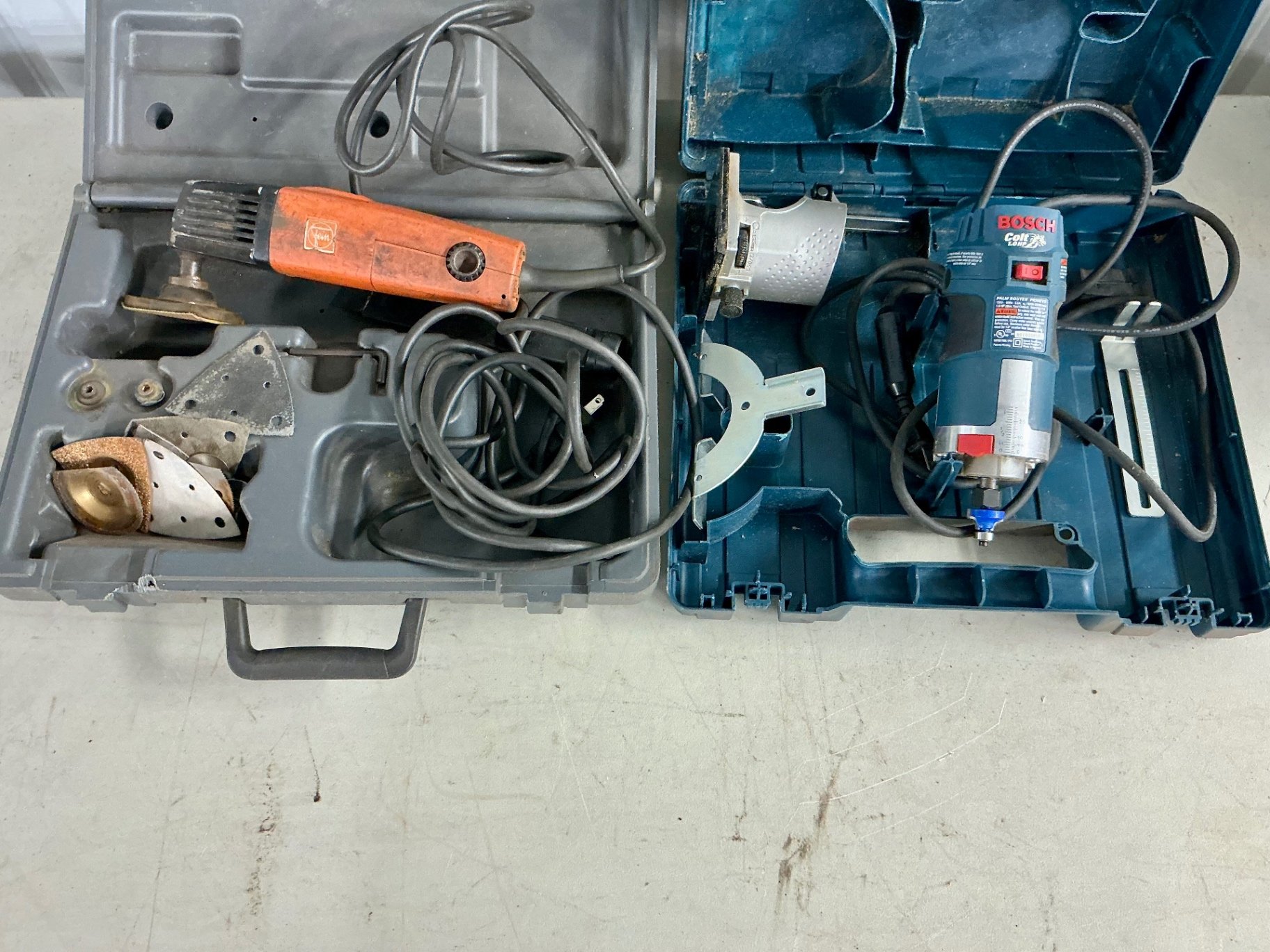 Multi-tool and blue Bosch palm router with accessories - image 1 of 5