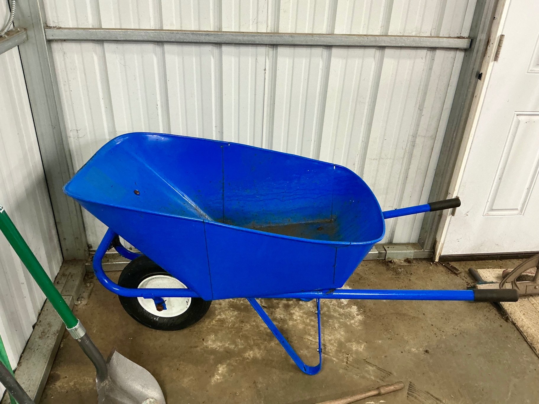 Blue wheelbarrow with garden tools and hose - image 6 of 6