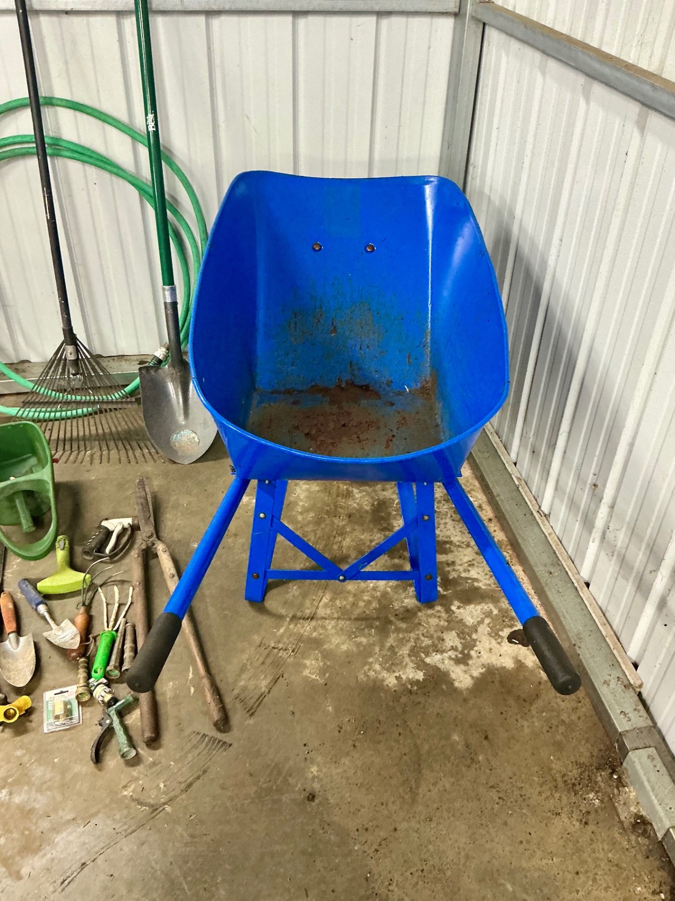 Blue wheelbarrow with garden tools and hose - image 4 of 6