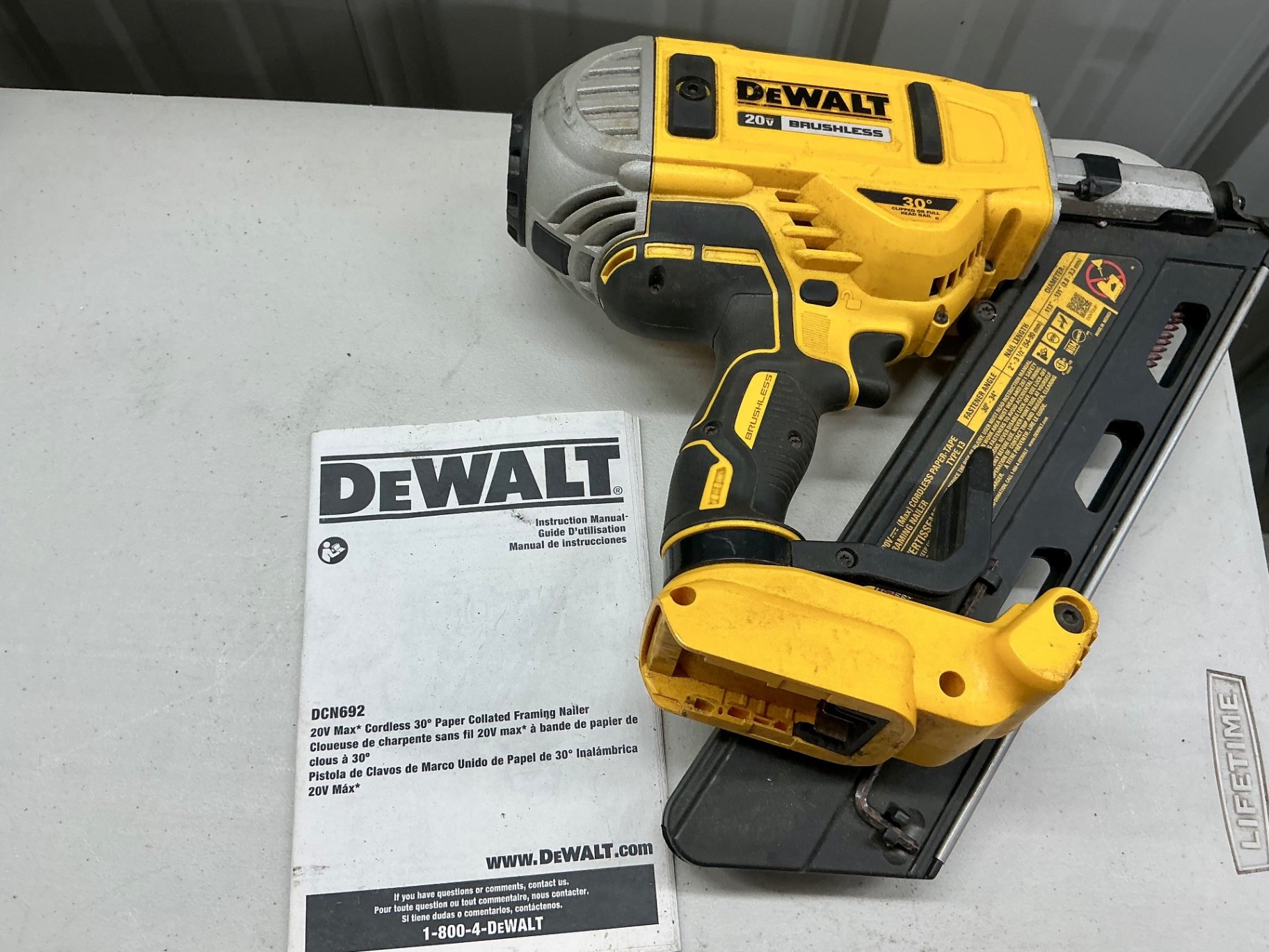 DeWalt 20V Max cordless framing nailer with charger, manual, and Paslode RoundDrive nails - image 1 of 5