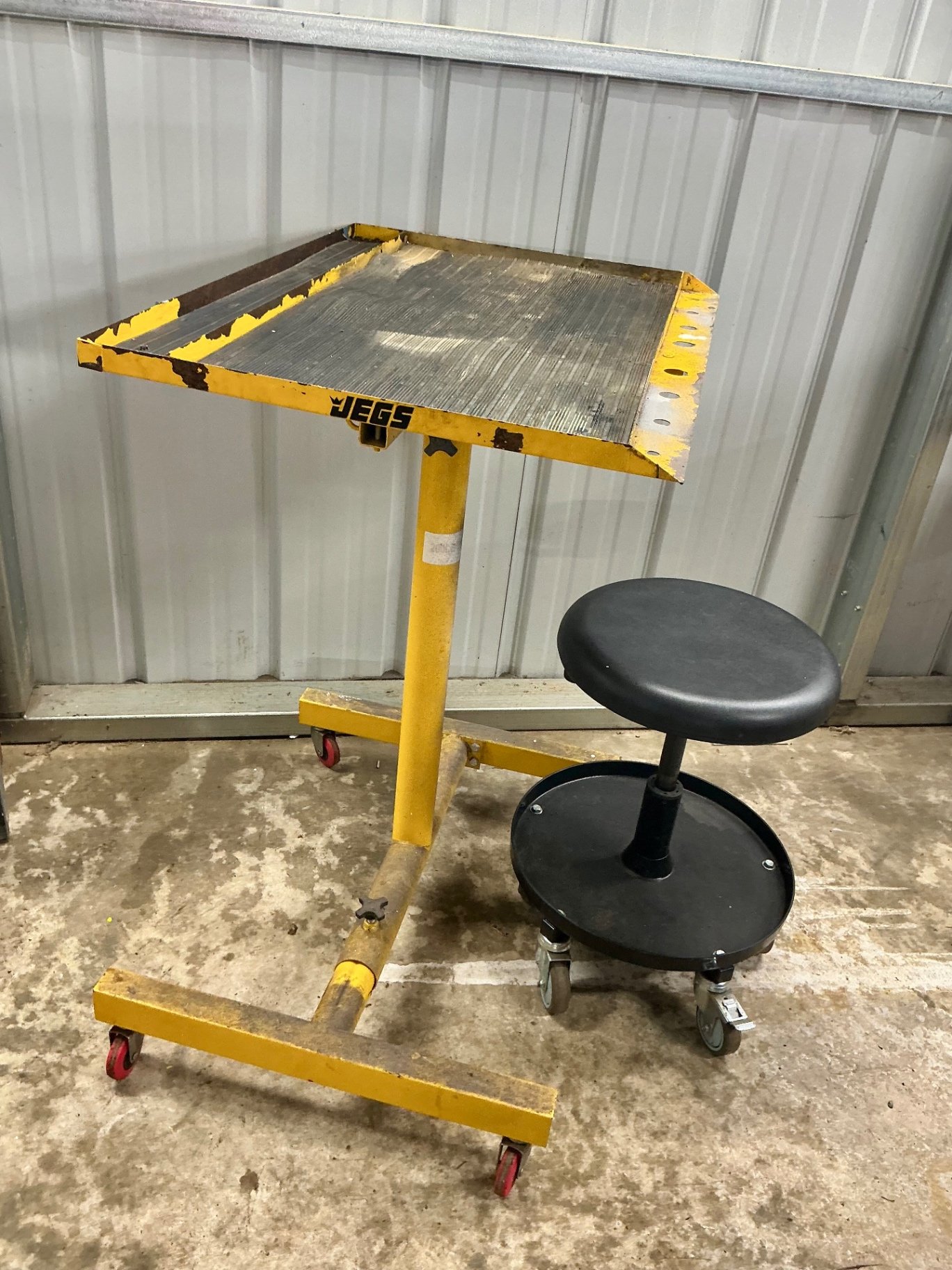 Yellow mobile work stand with ribbed tabletop and rolling stool - image 1 of 3