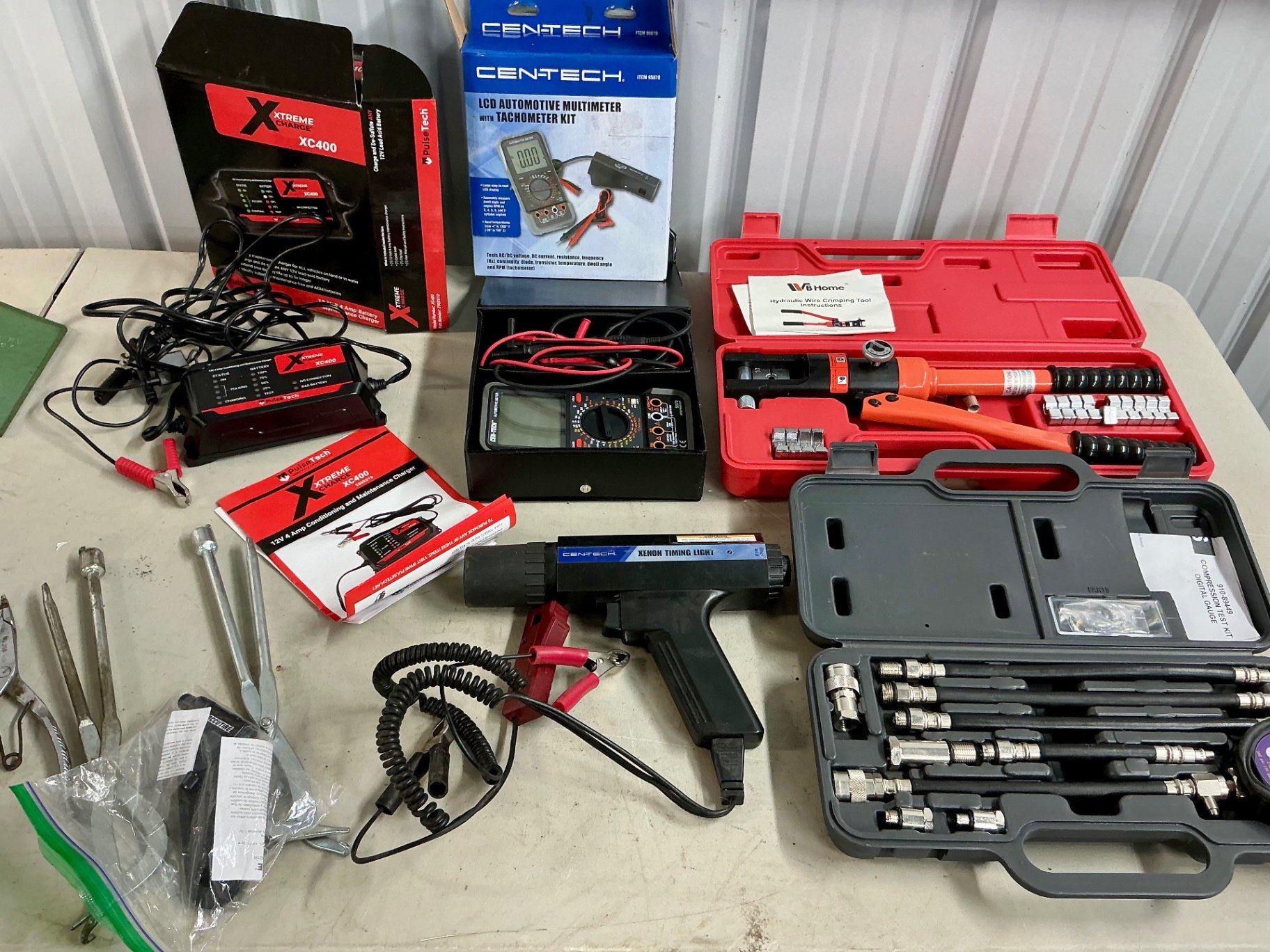 Automotive electrical tool kit with multimeter, battery charger, crimping tool, and socket set - image 1 of 6