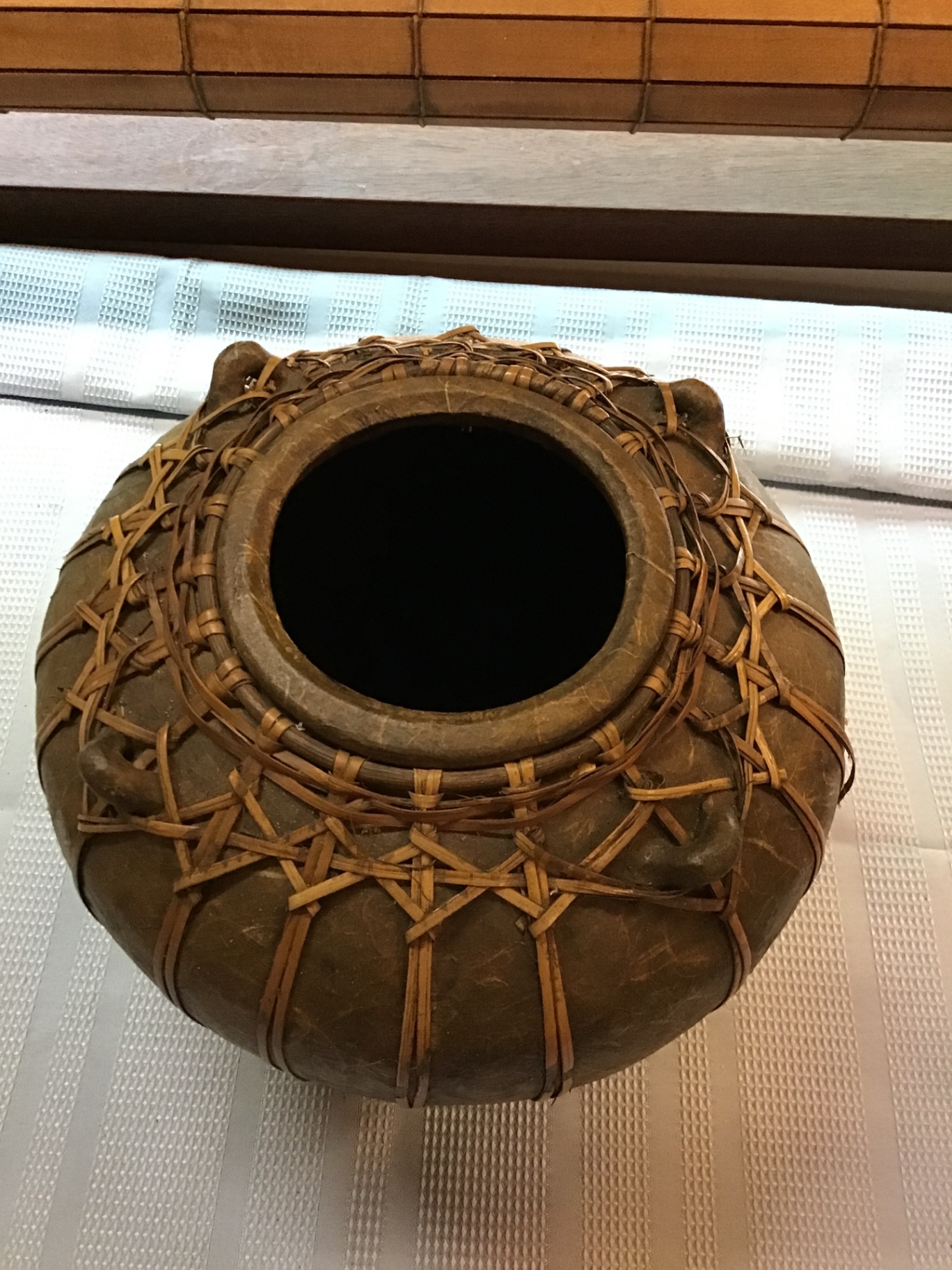 Round ceramic pot wrapped in woven rattan - image 2 of 4