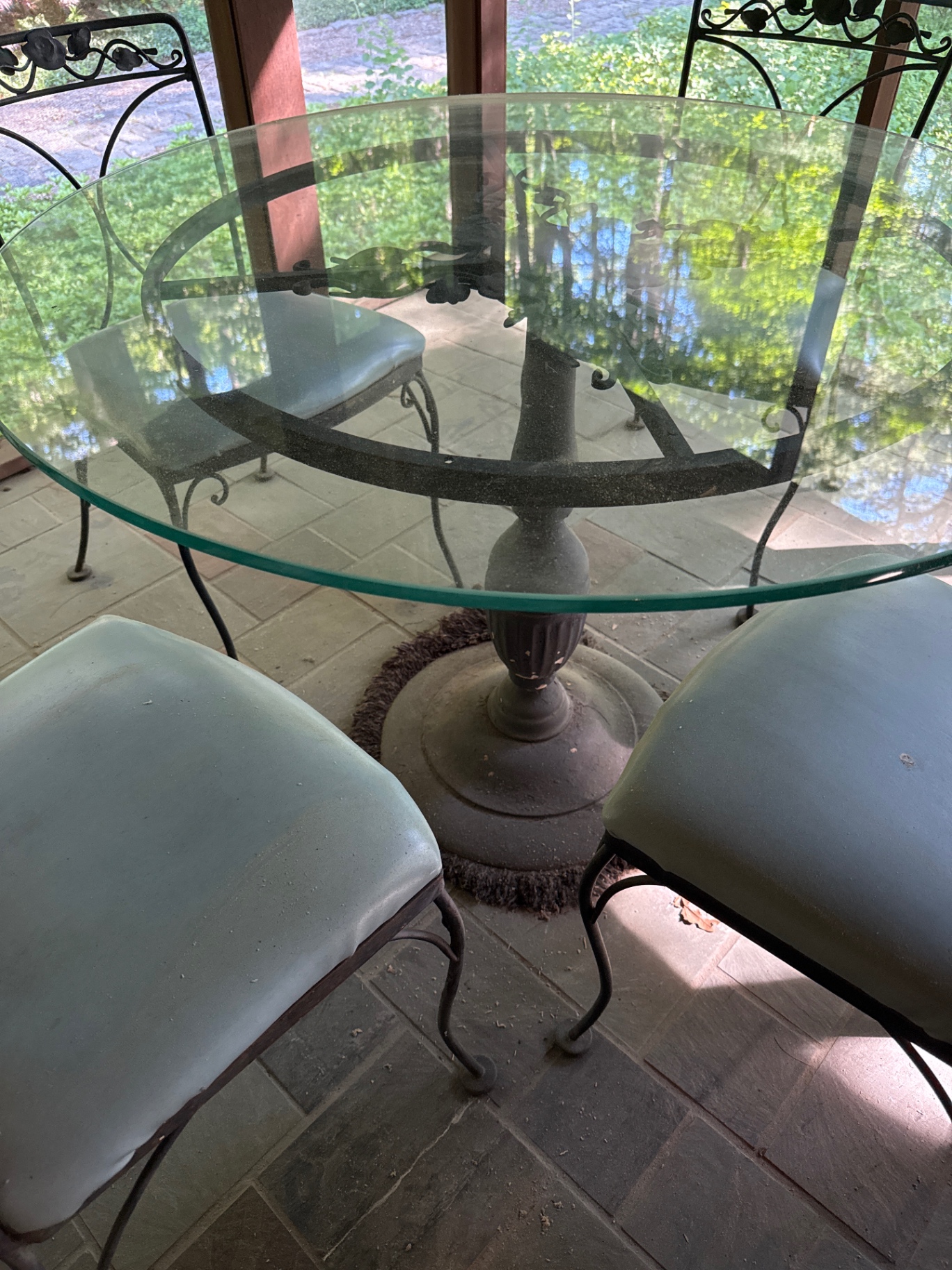 Round glass dining table with four cushioned metal chairs - image 3 of 4
