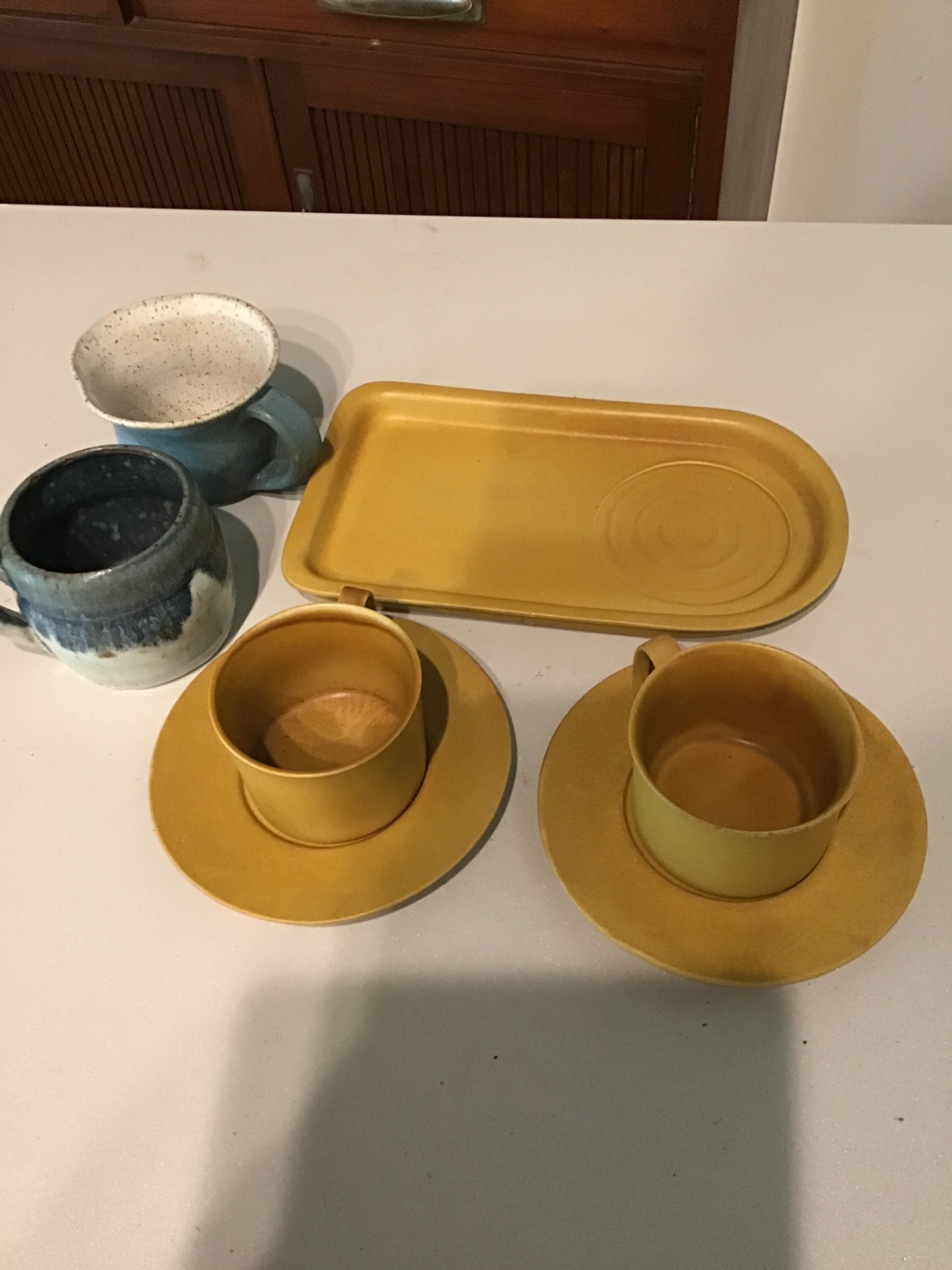 Yellow ceramic cup and saucer set with tray and blue mugs - image 1 of 2