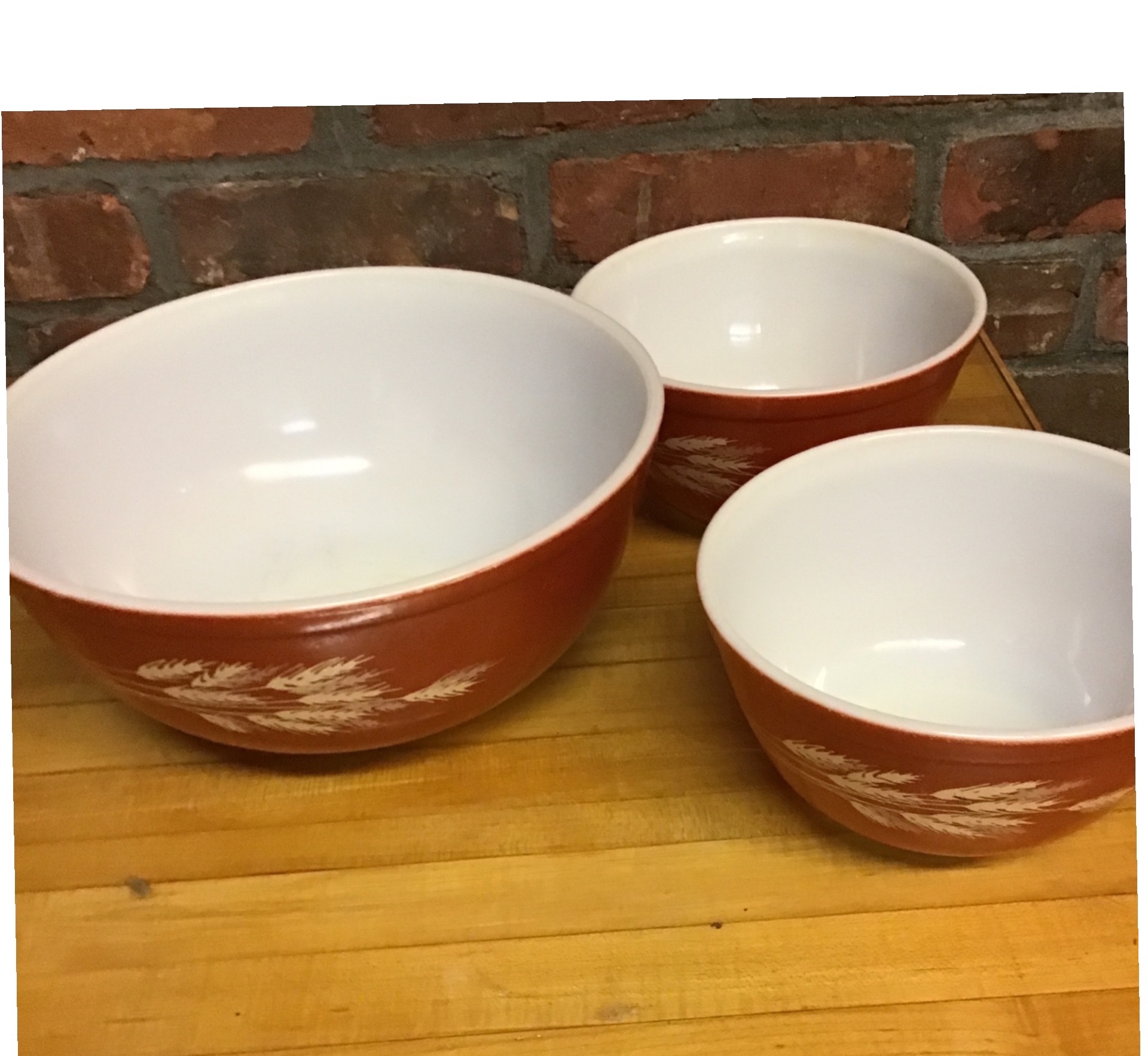 Set of three red PYREX exterior ceramic bowls - image 1 of 2