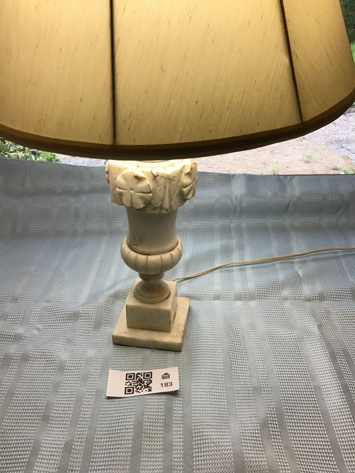 Table lamp with carved pedestal base and beige lampshade - image 1 of 3