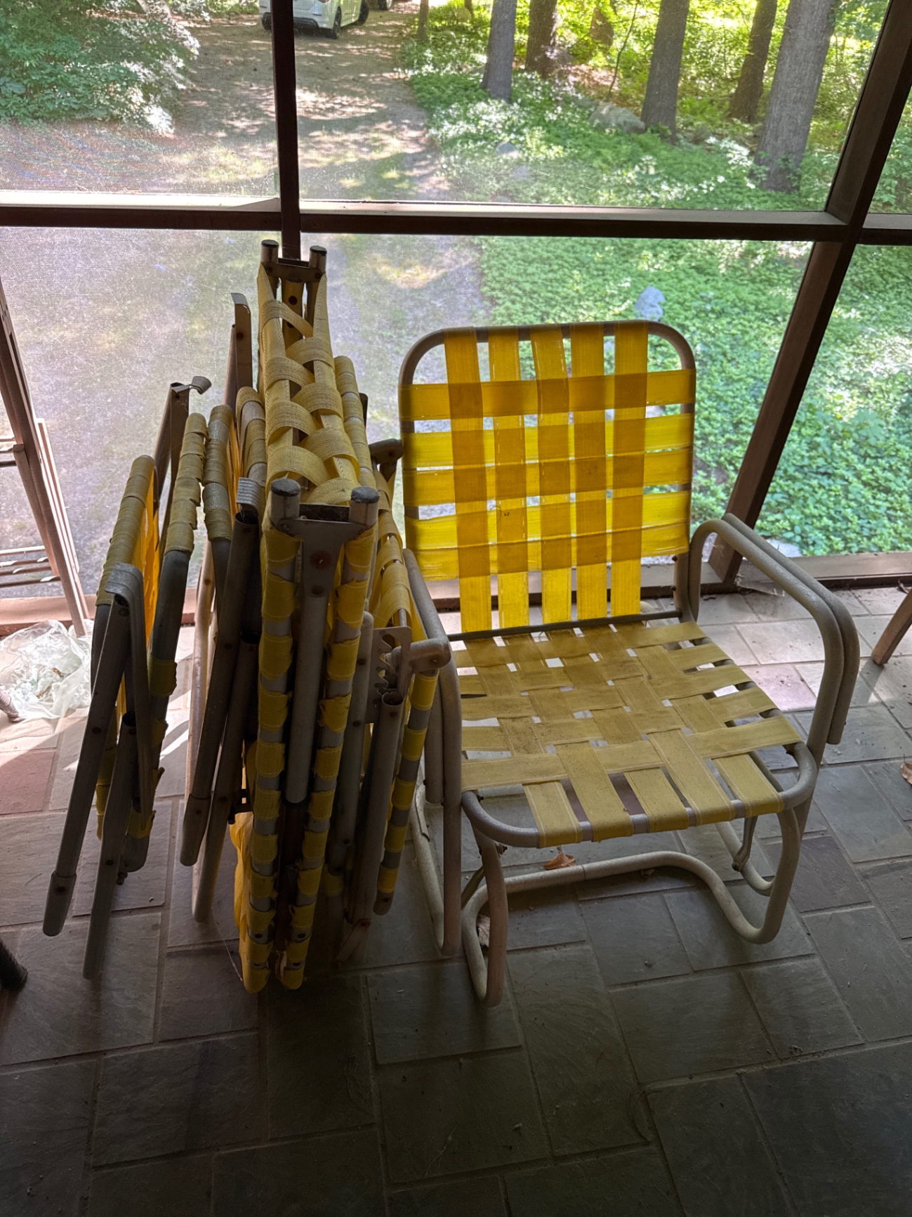 Stack of folding outdoor chairs with yellow woven straps and a yellow woven chair - image 1 of 1